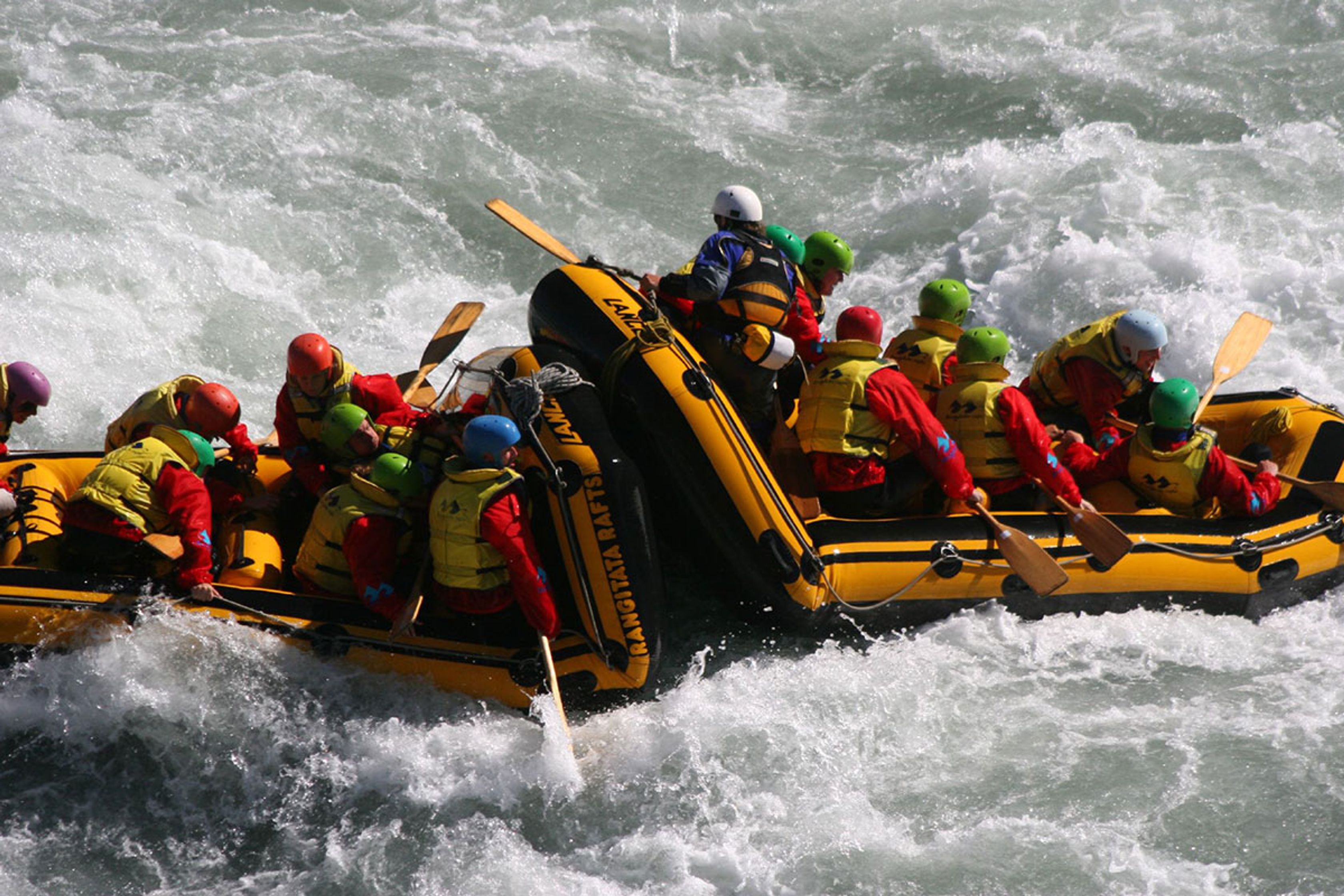 Friends River rafting Iceland in a crazy water