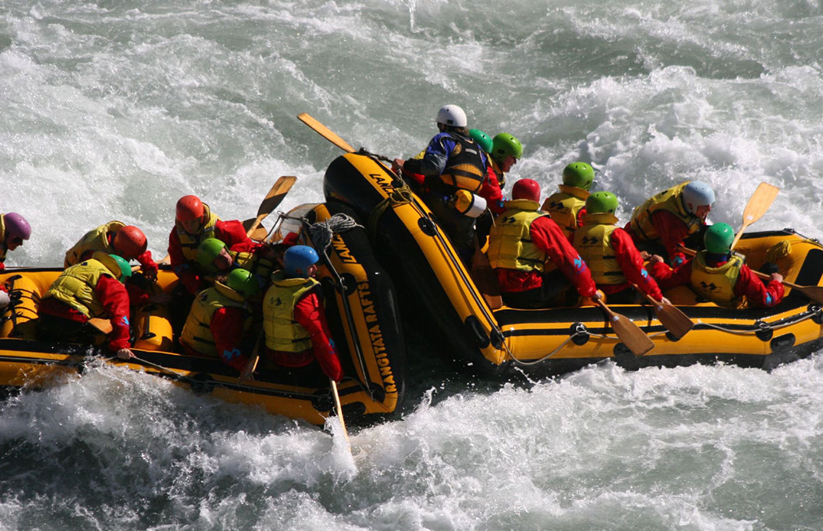 Friends River rafting Iceland in a crazy water