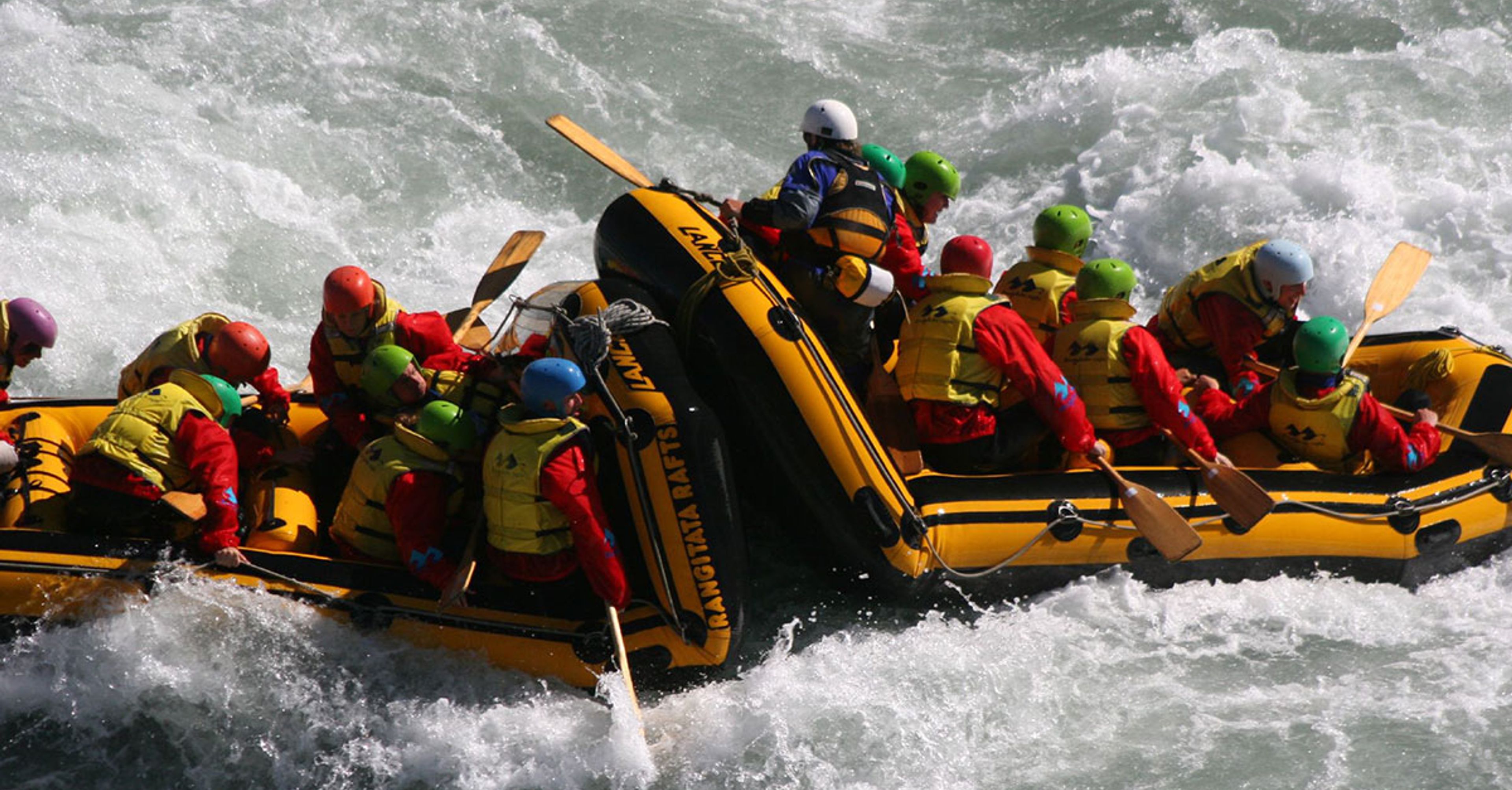 Friends River rafting Iceland in a crazy water
