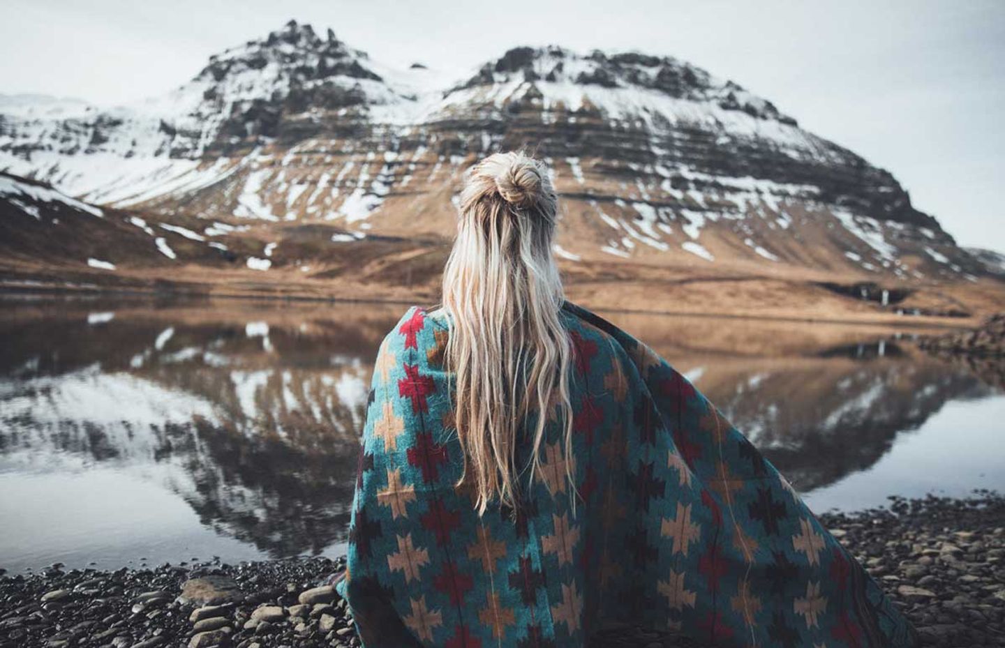 Woman in front of a snowy mountain in Iceland 