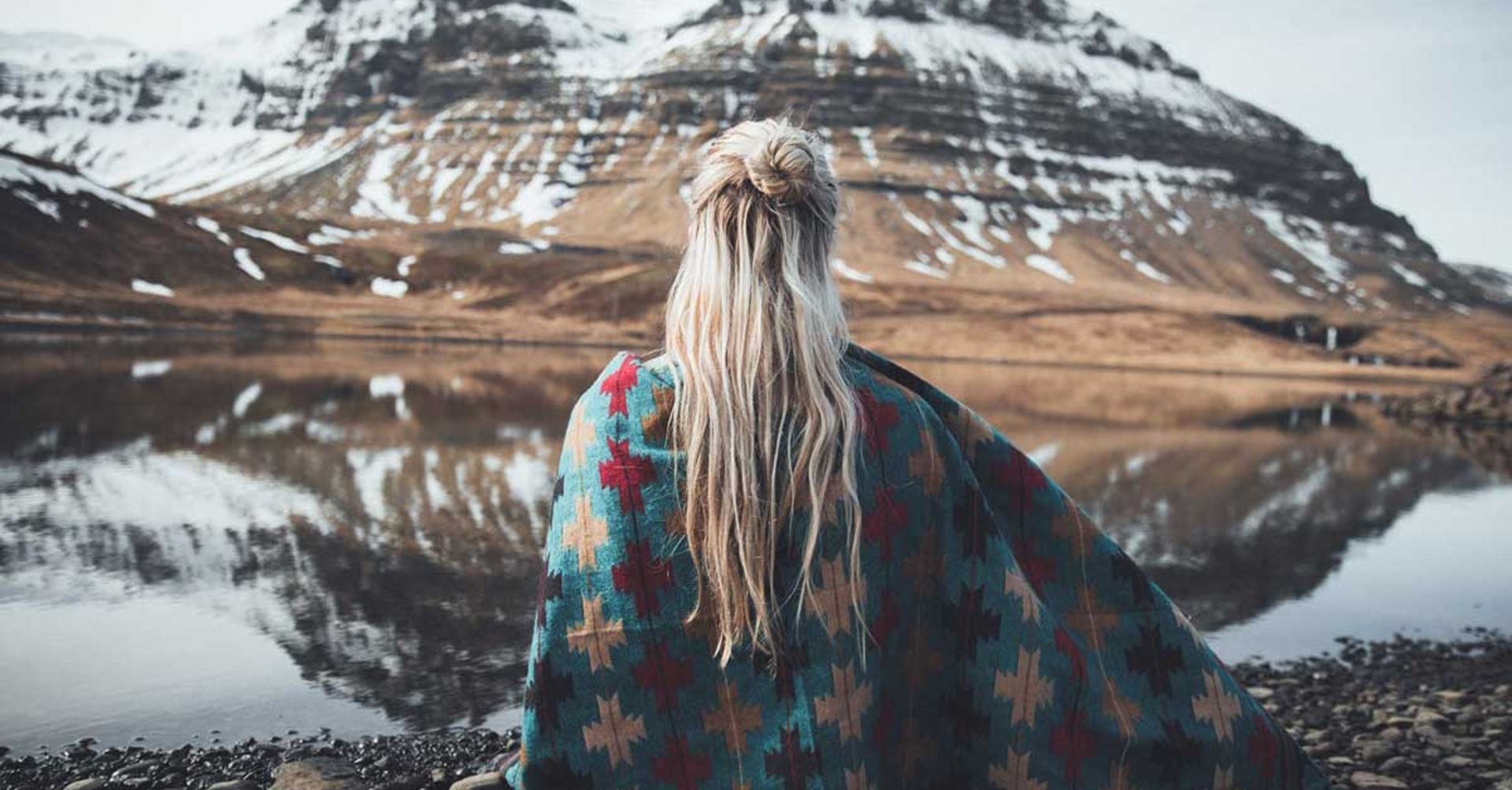 Woman in front of a snowy mountain in Iceland 