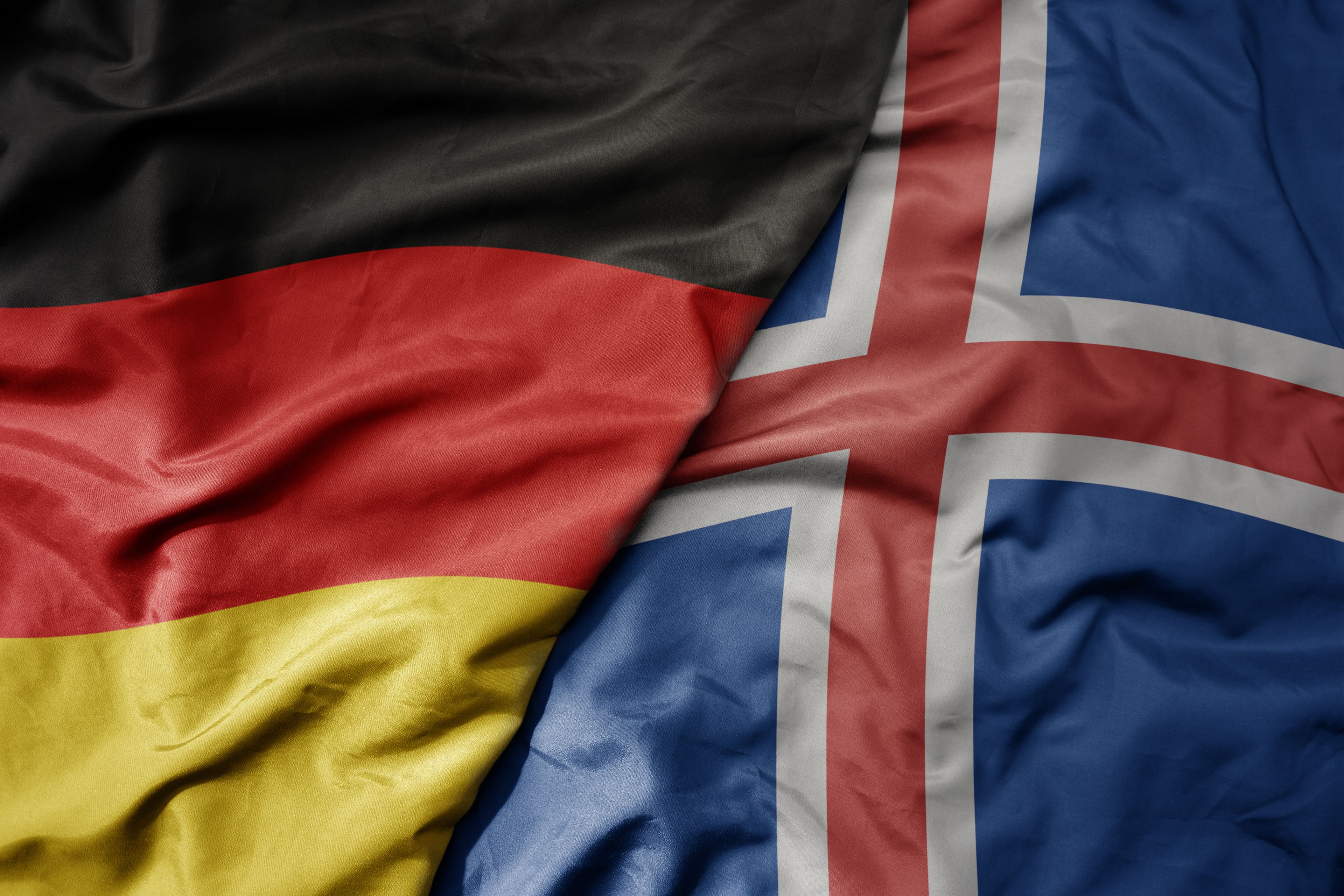 national colorful flag of germany and national flag of iceland .