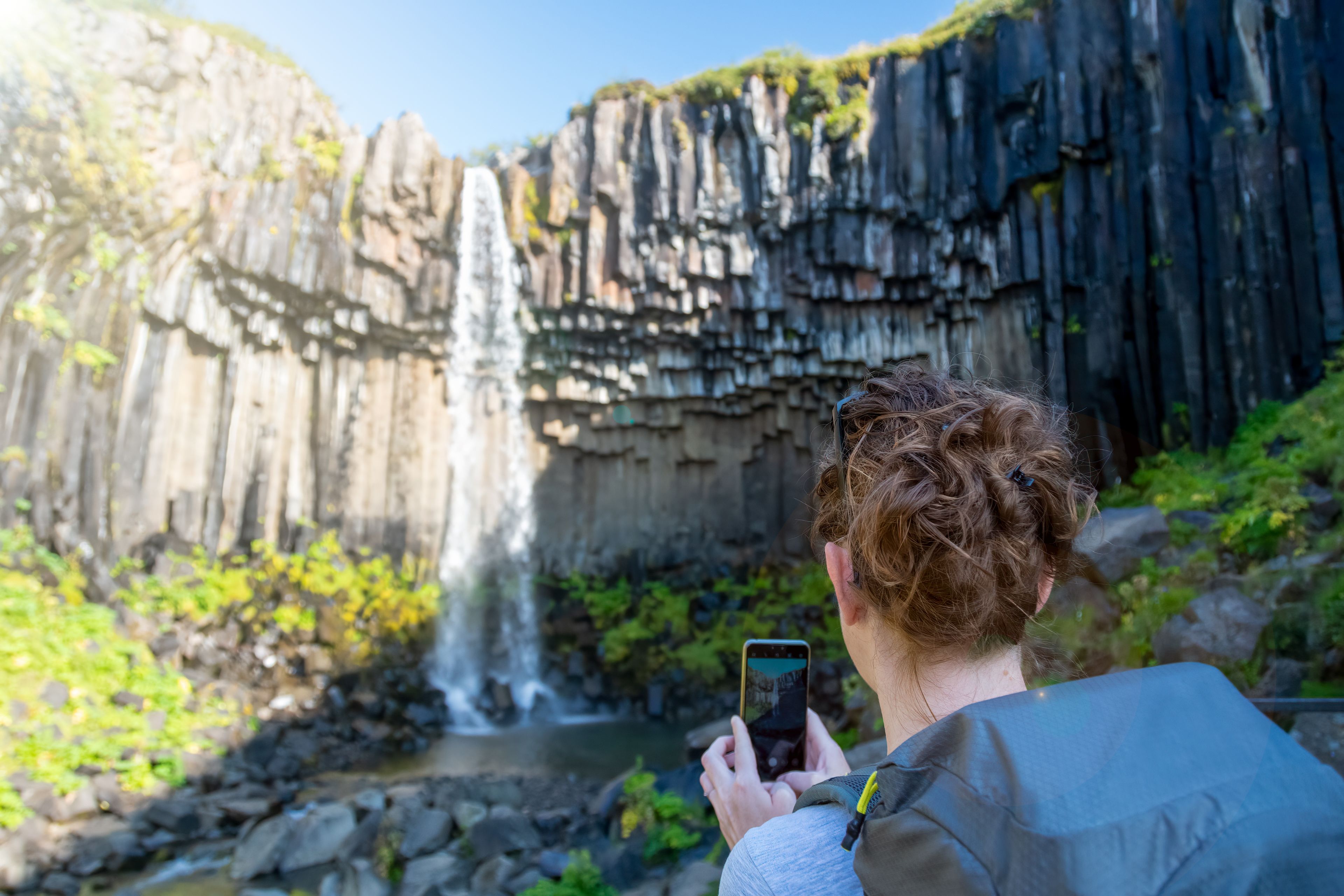 Svartifoss Waterfall in Iceland shines under the summer sun during July and August.