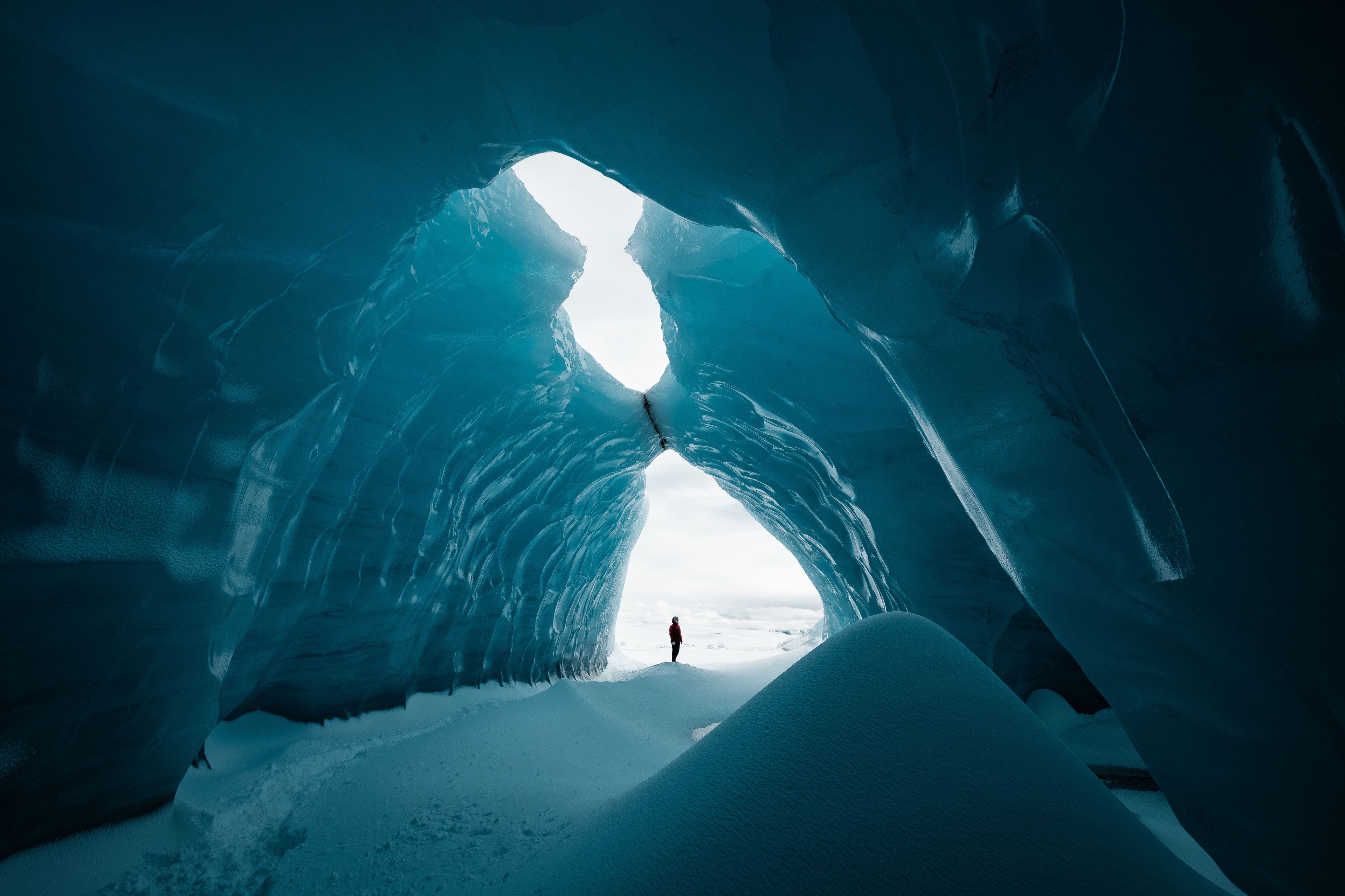 Person is standing in a ice cave in Vatnajökull glacier Iceland