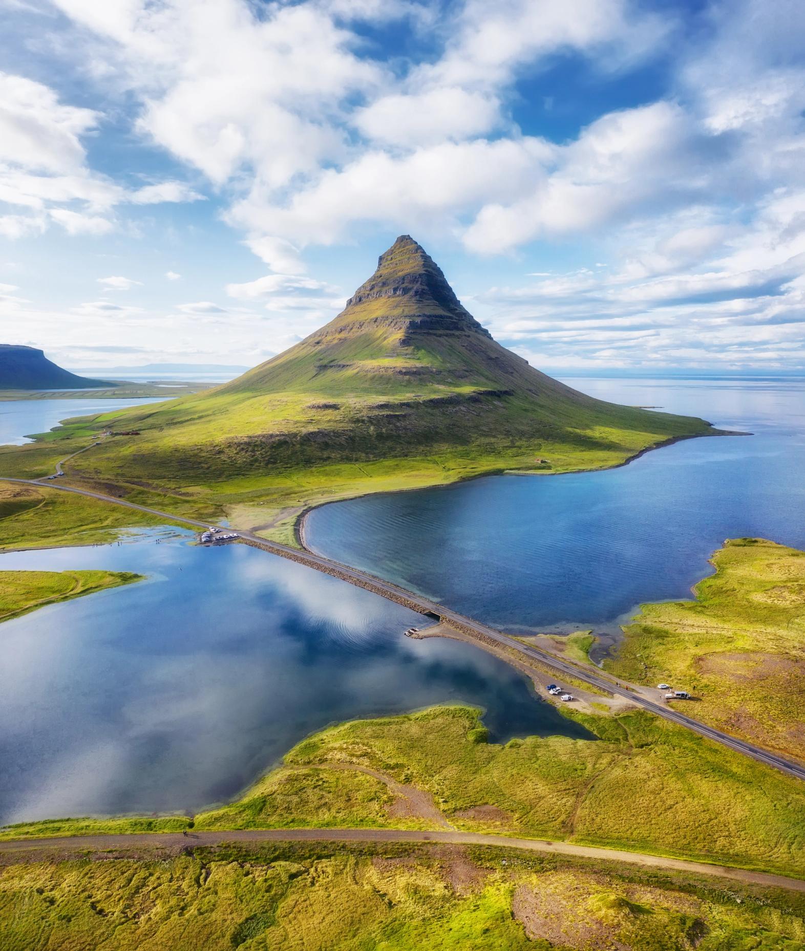 Kirkjufell with a car driving towards it