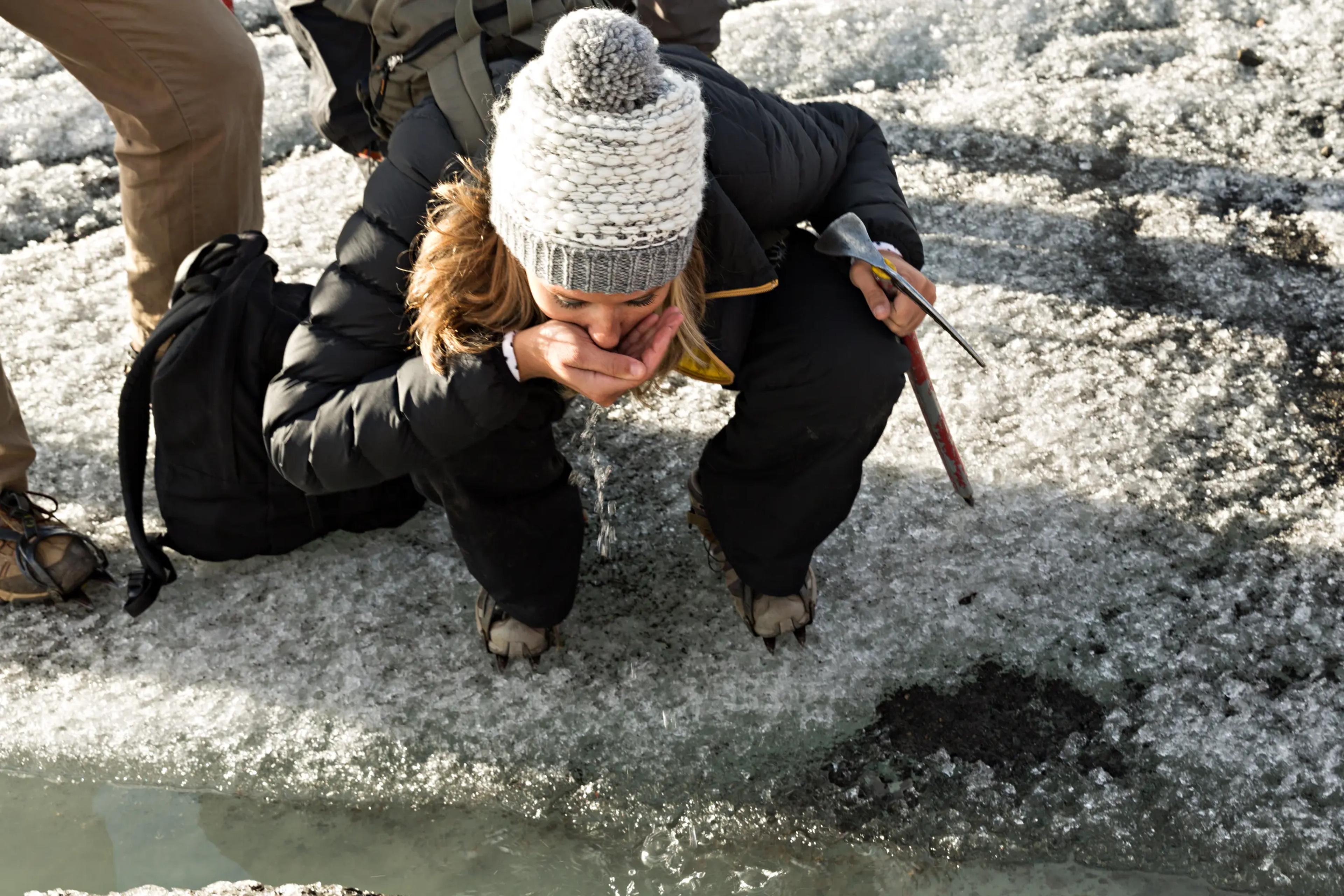 Tourist drinking water from a Glacier Lagoon