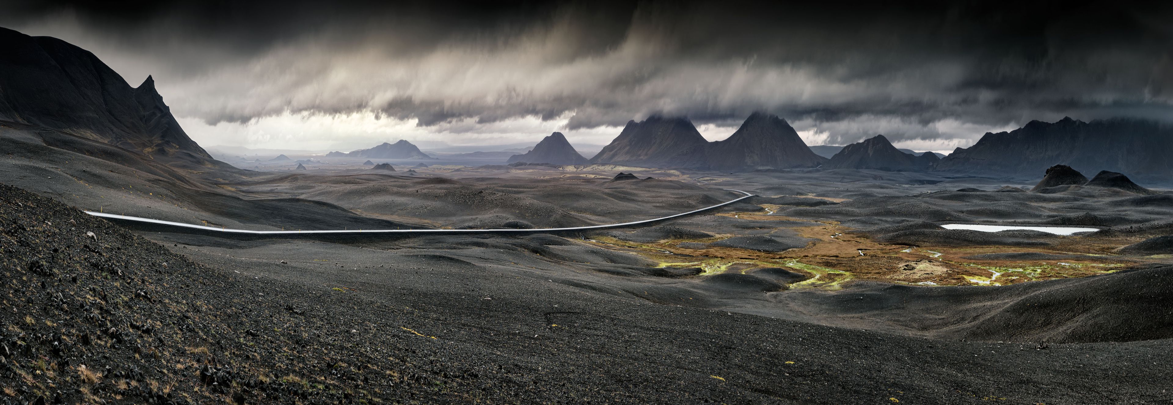 Iceland volcanic landscape with a lake and mountains in the background