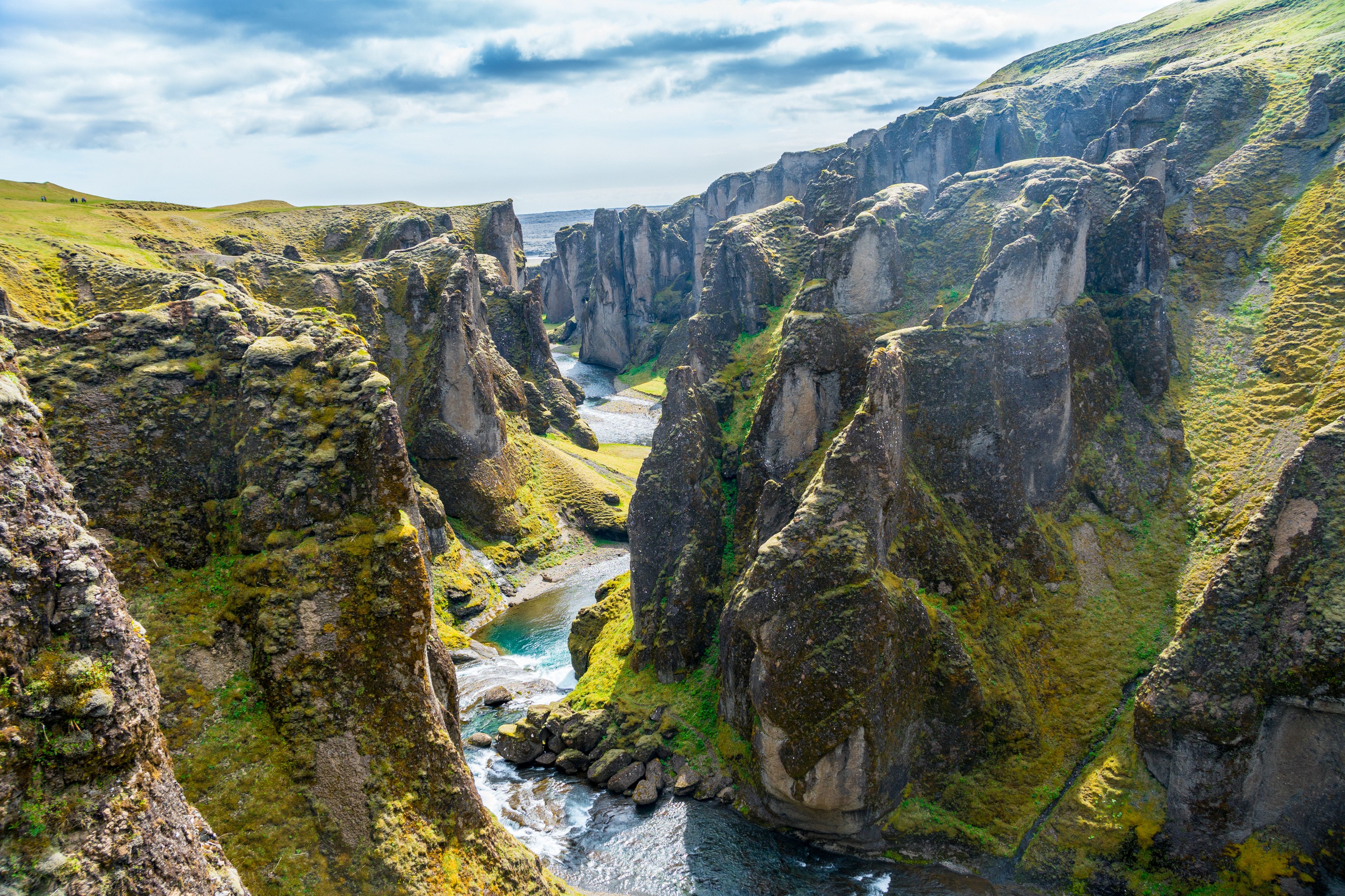 Fjaðrárgljúfur Canyon with river flowing through it