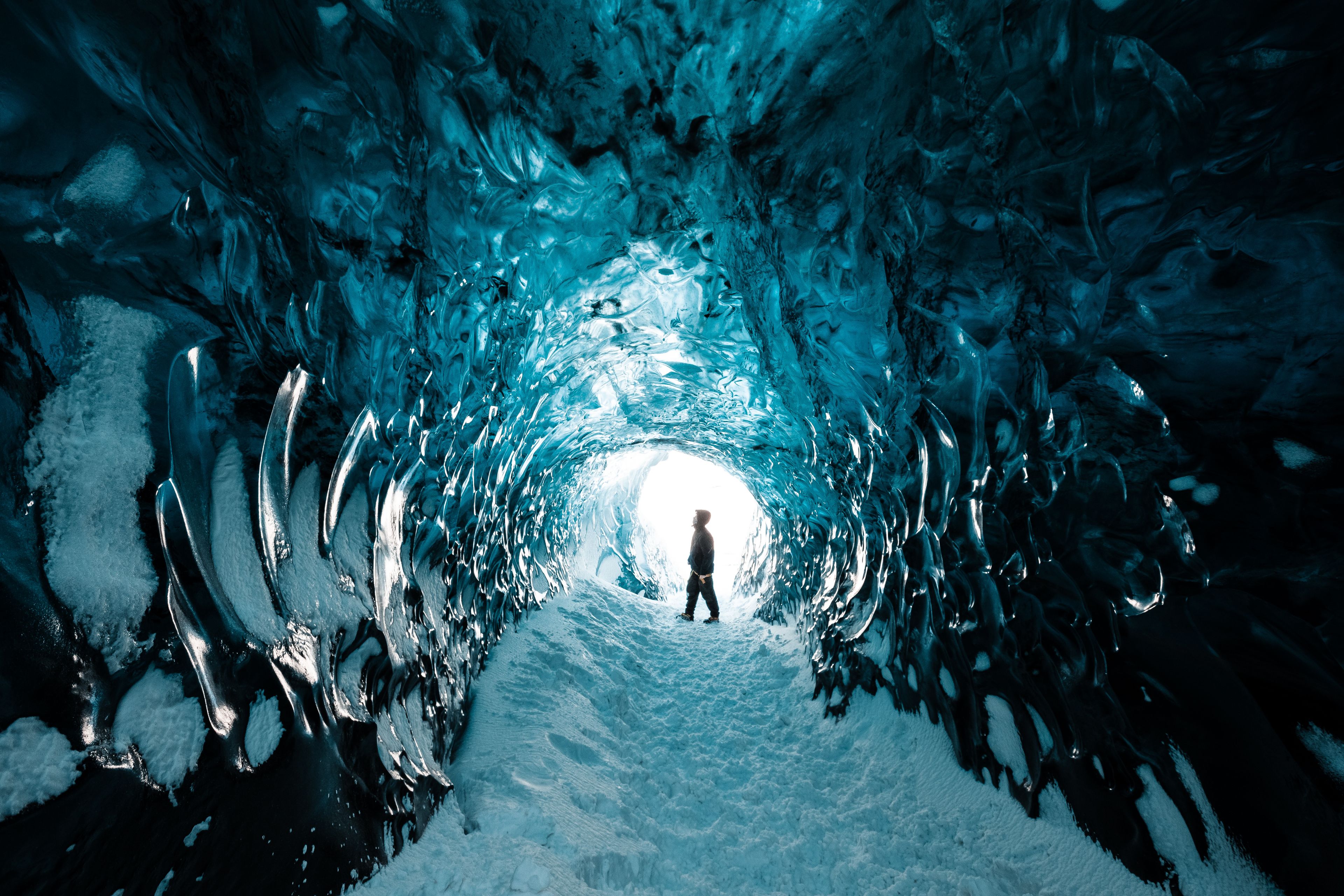 A view of an ice cave with blue light inside