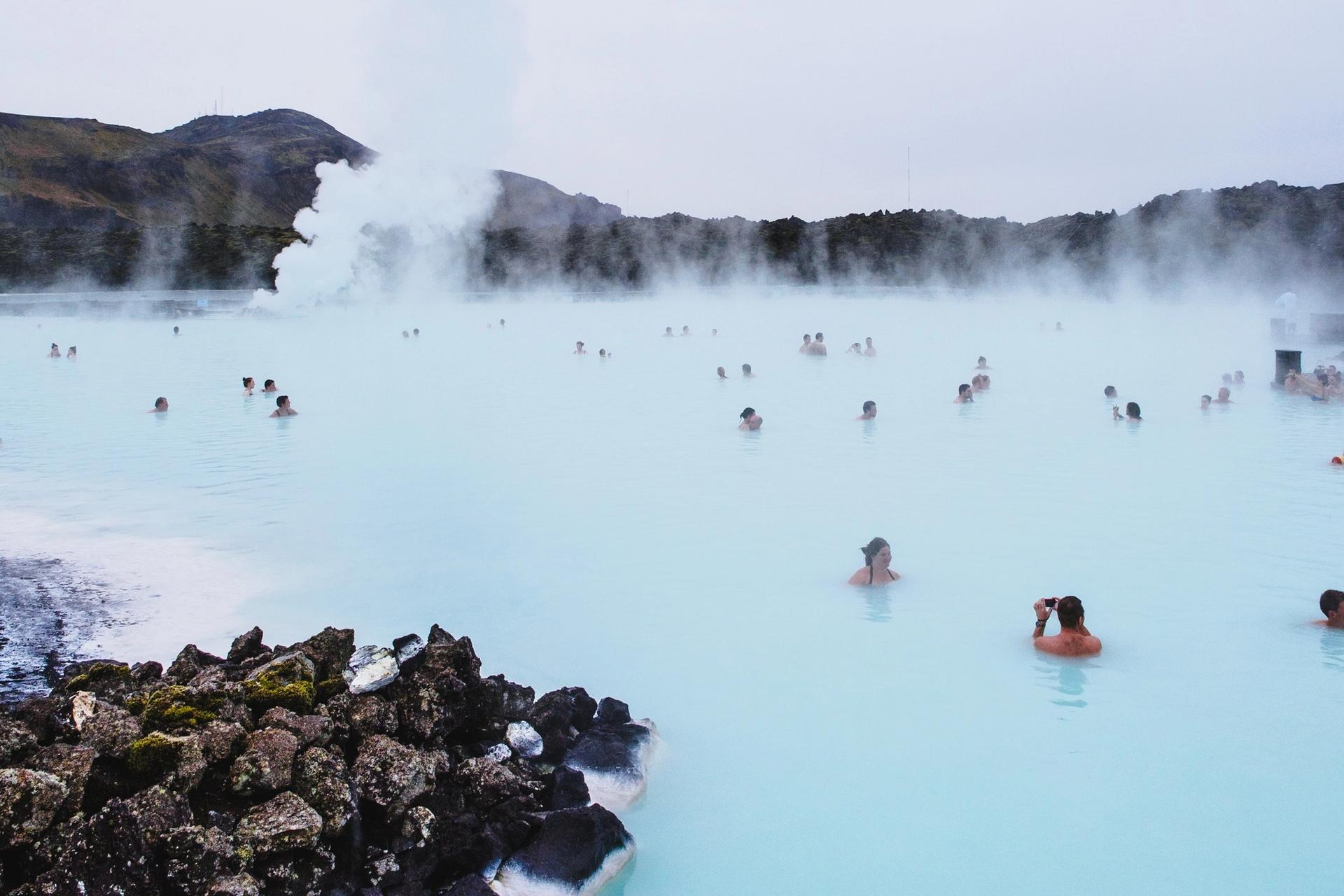 People relaxing in Blue Lagoon hot spring in Iceland