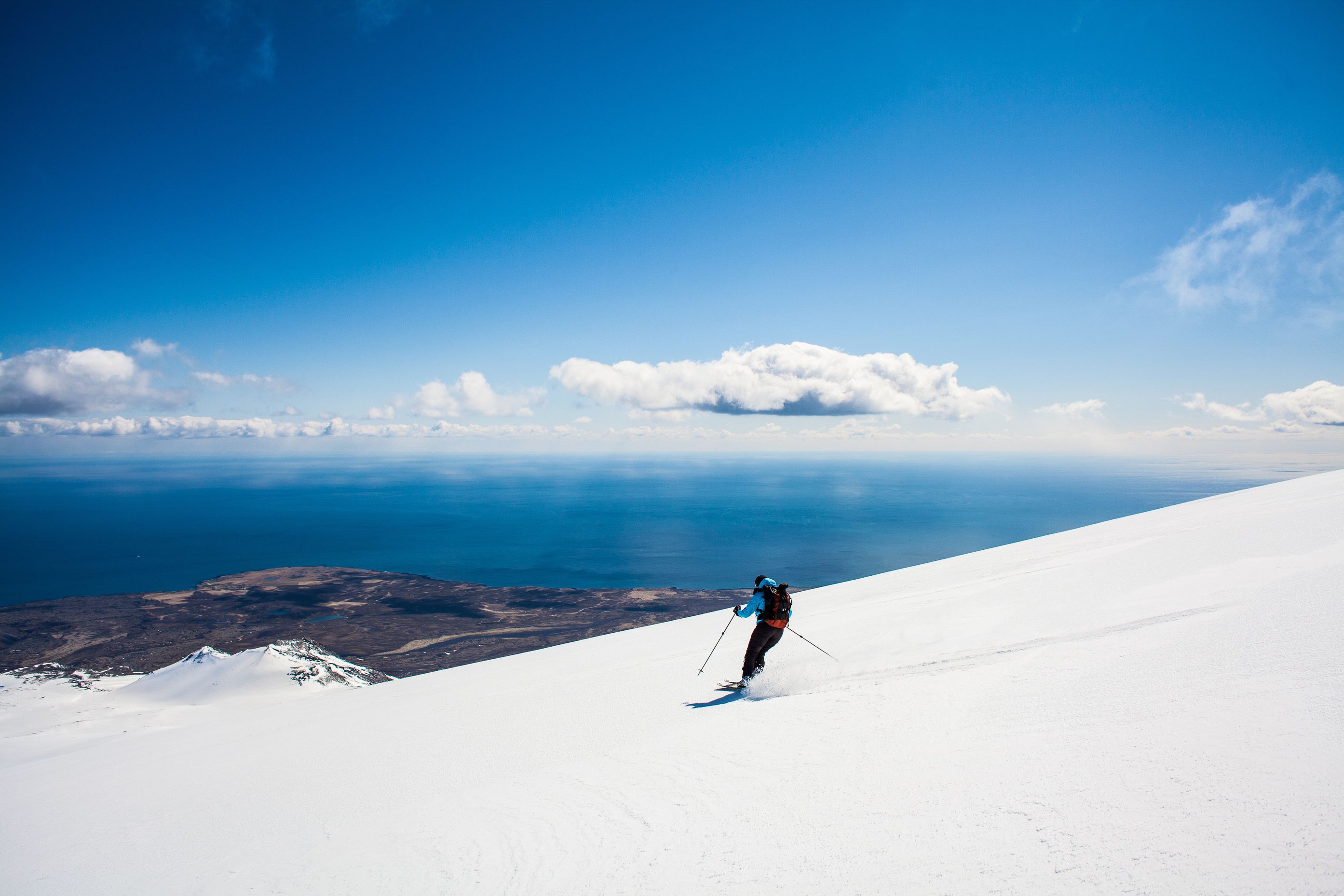 Man skiing in Iceland next to the ocean