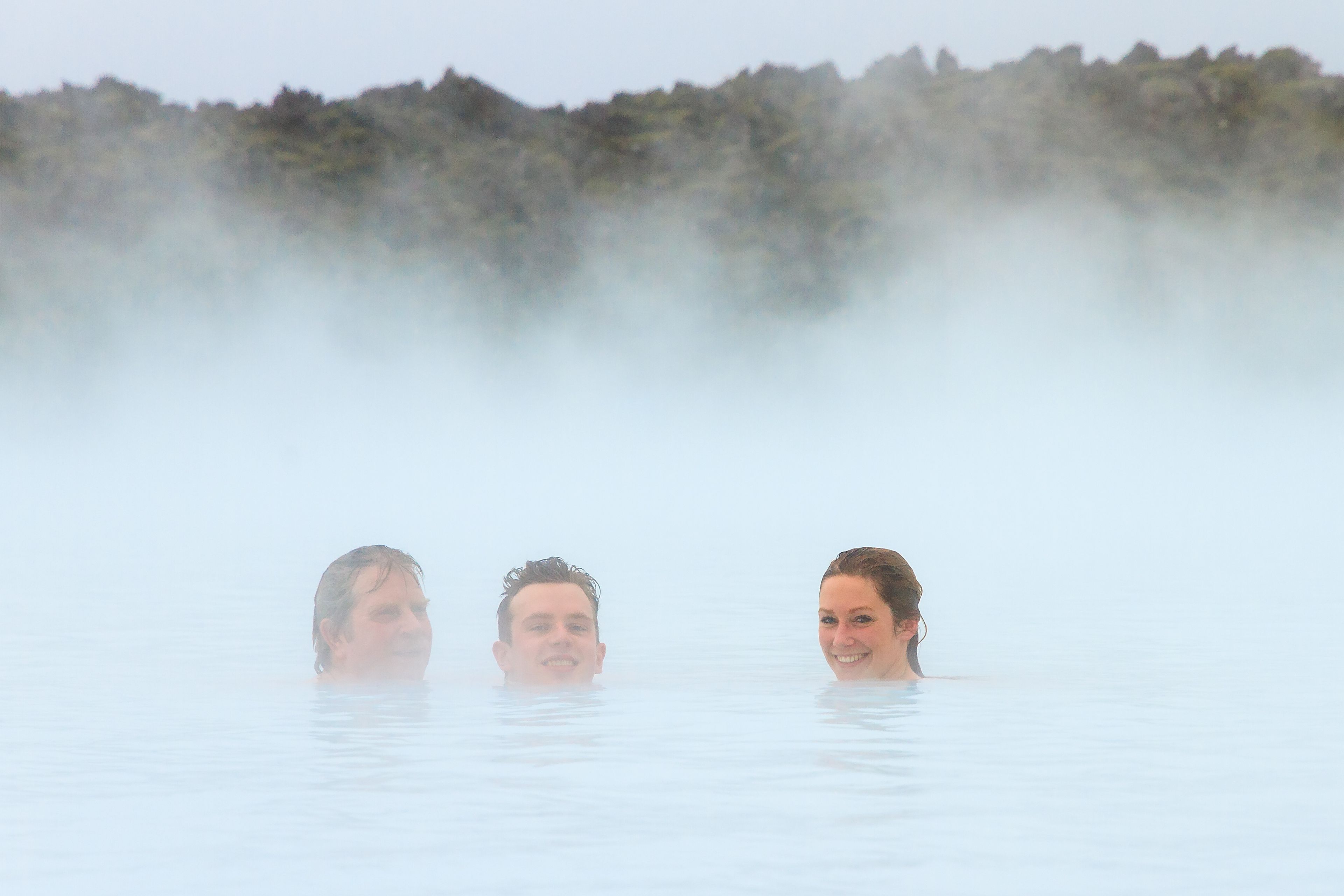 3 people having a good time in one of the many hot springs in Iceland