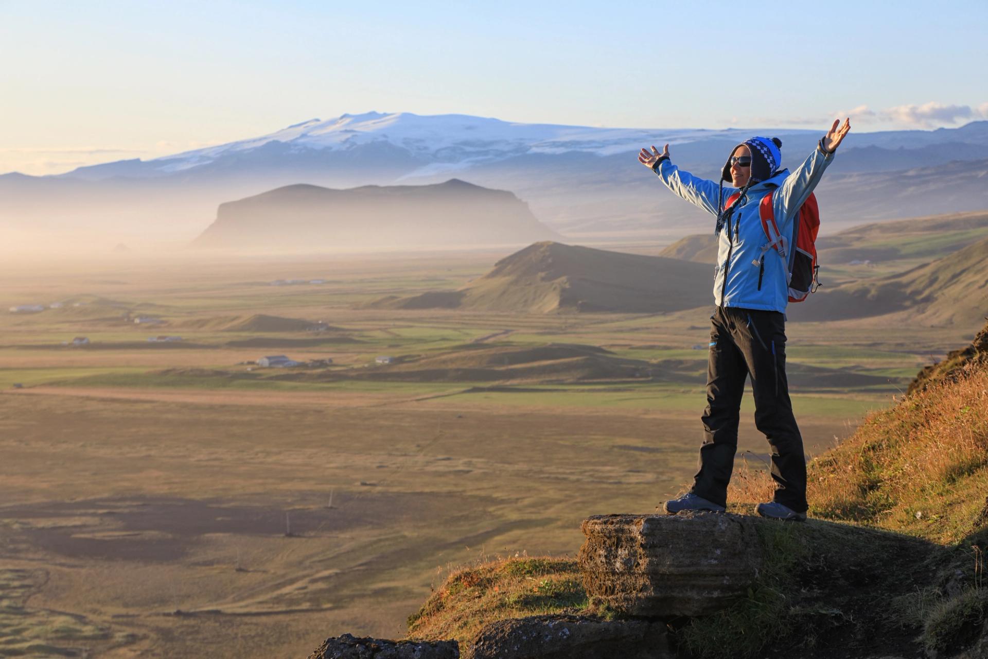 A person wearing warm clothes and hiking boots, ready to explore Iceland in the off season