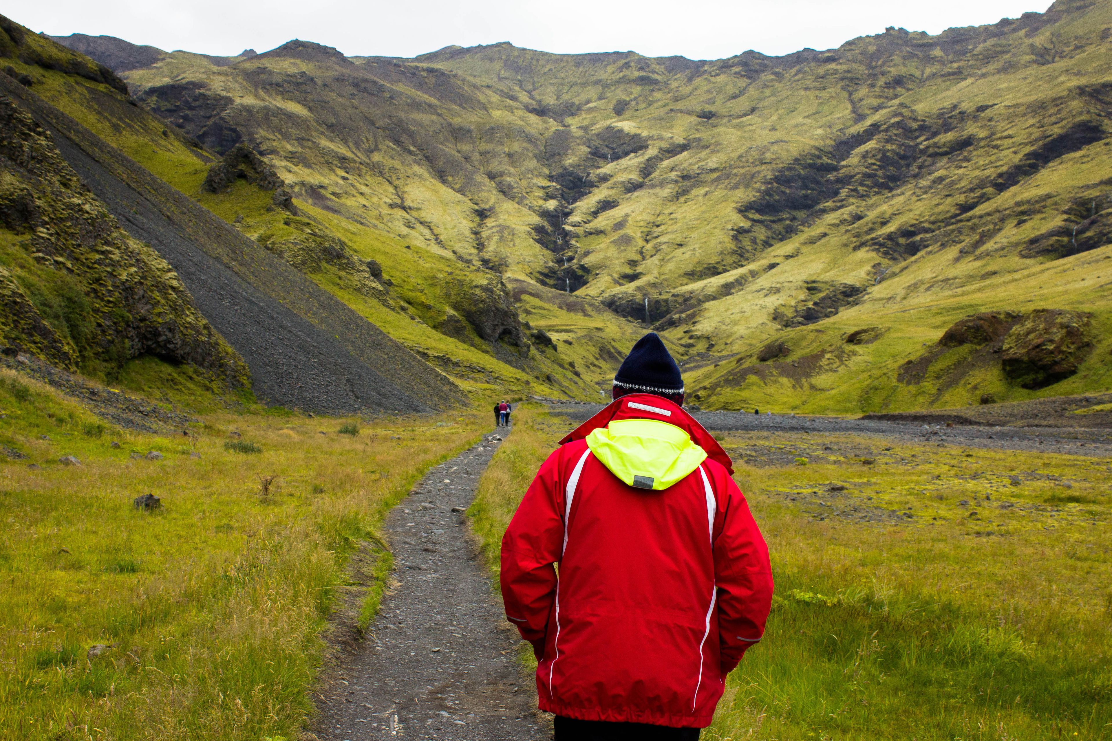 a man walking to the seljavallalaug hot spring in iceland