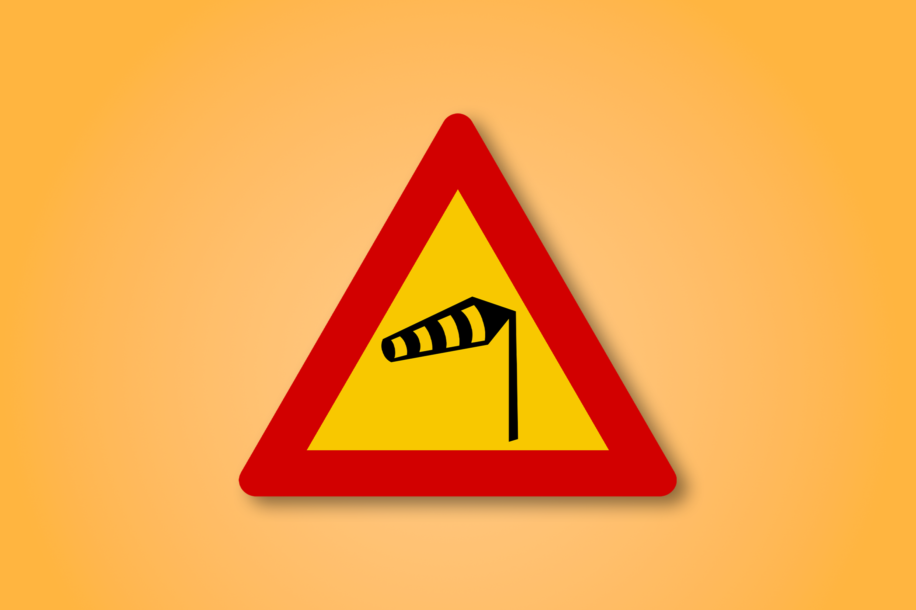 一块红色和黄色的三角形路标，中间有风的图标。这个路标表示侧风。