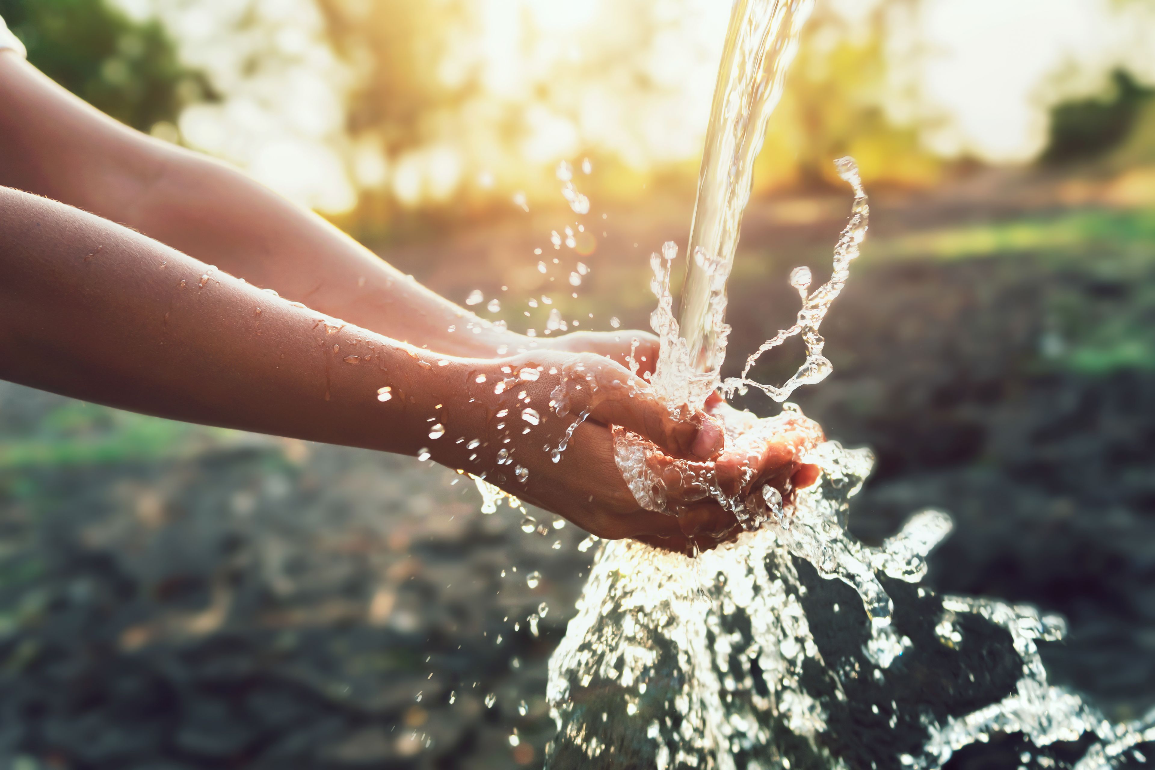 Girl washing her hand with water