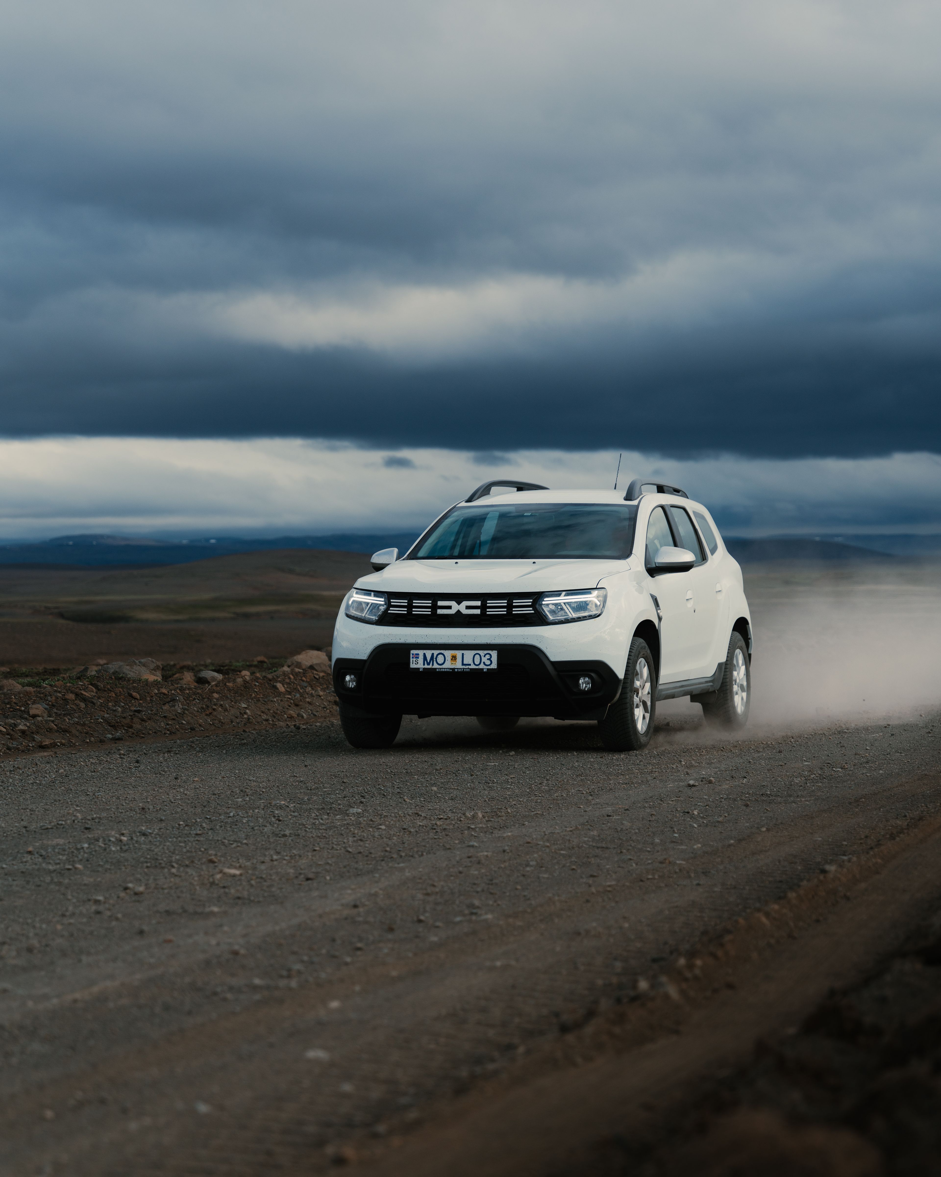 Dacia Duster rental car driving on gravel road in iceland