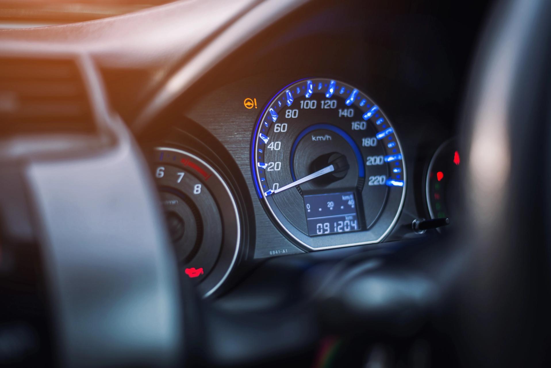 A detailed shot of the dashboard inside a rental car amidst the scenic beauty of Iceland.