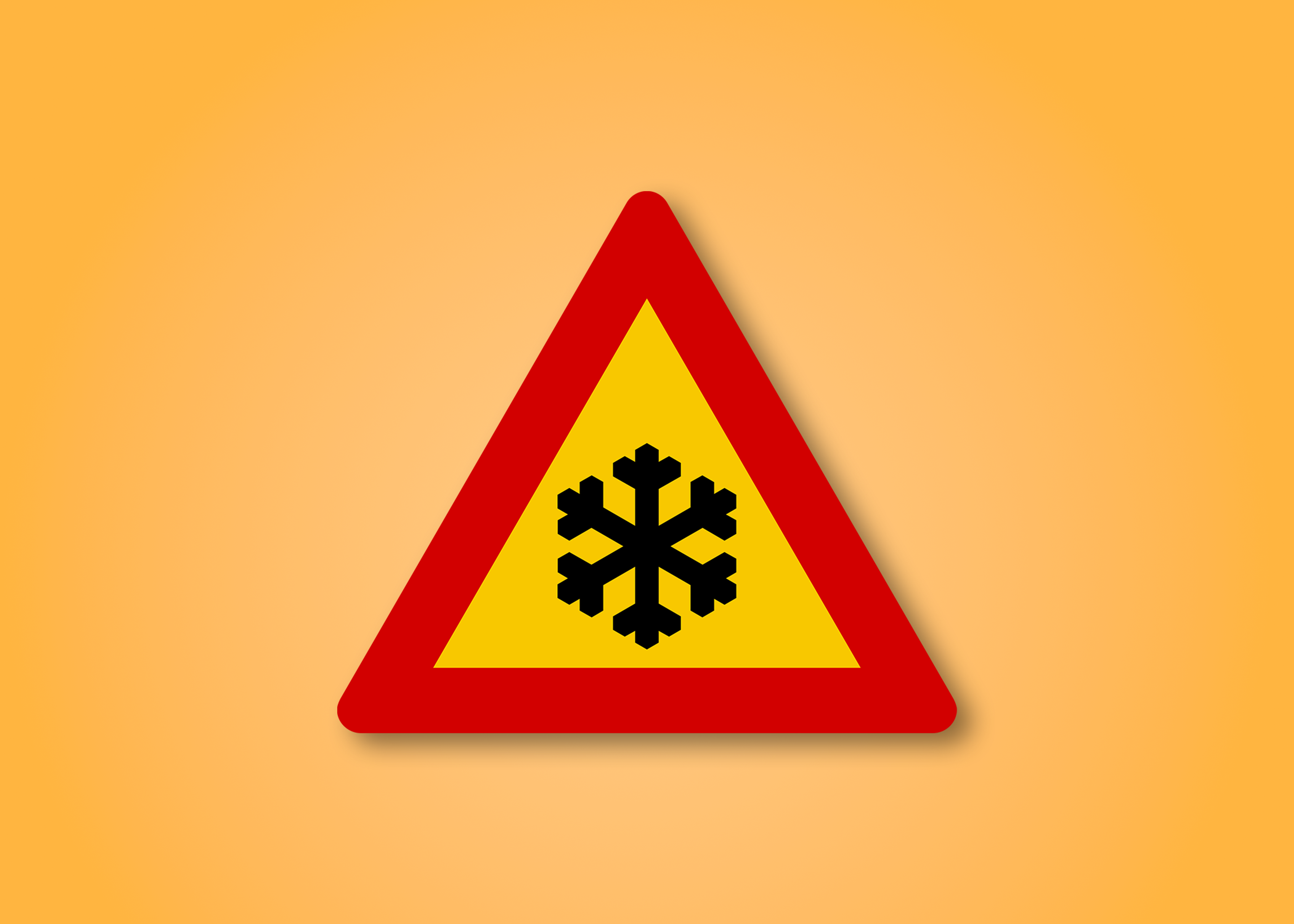 Red and yellow triangle road sign with a snow flake in the middle. This road sign means icy road.