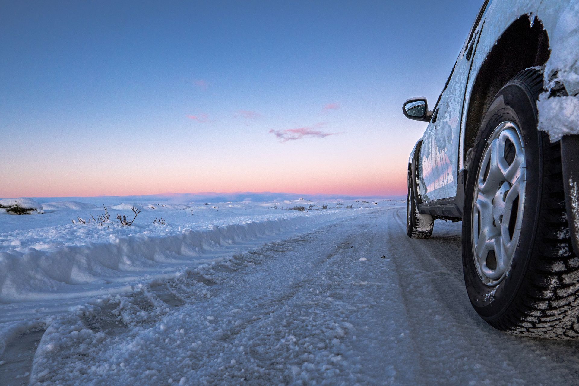 Sunset and car under the snow in Iceland