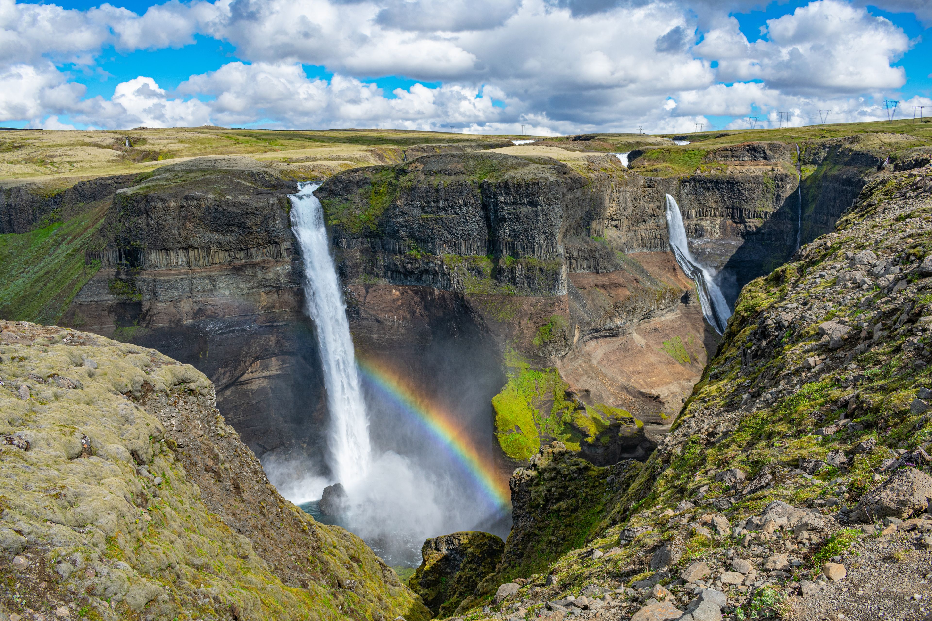 Haifoss waterfall with a rainbow and Granni in the background