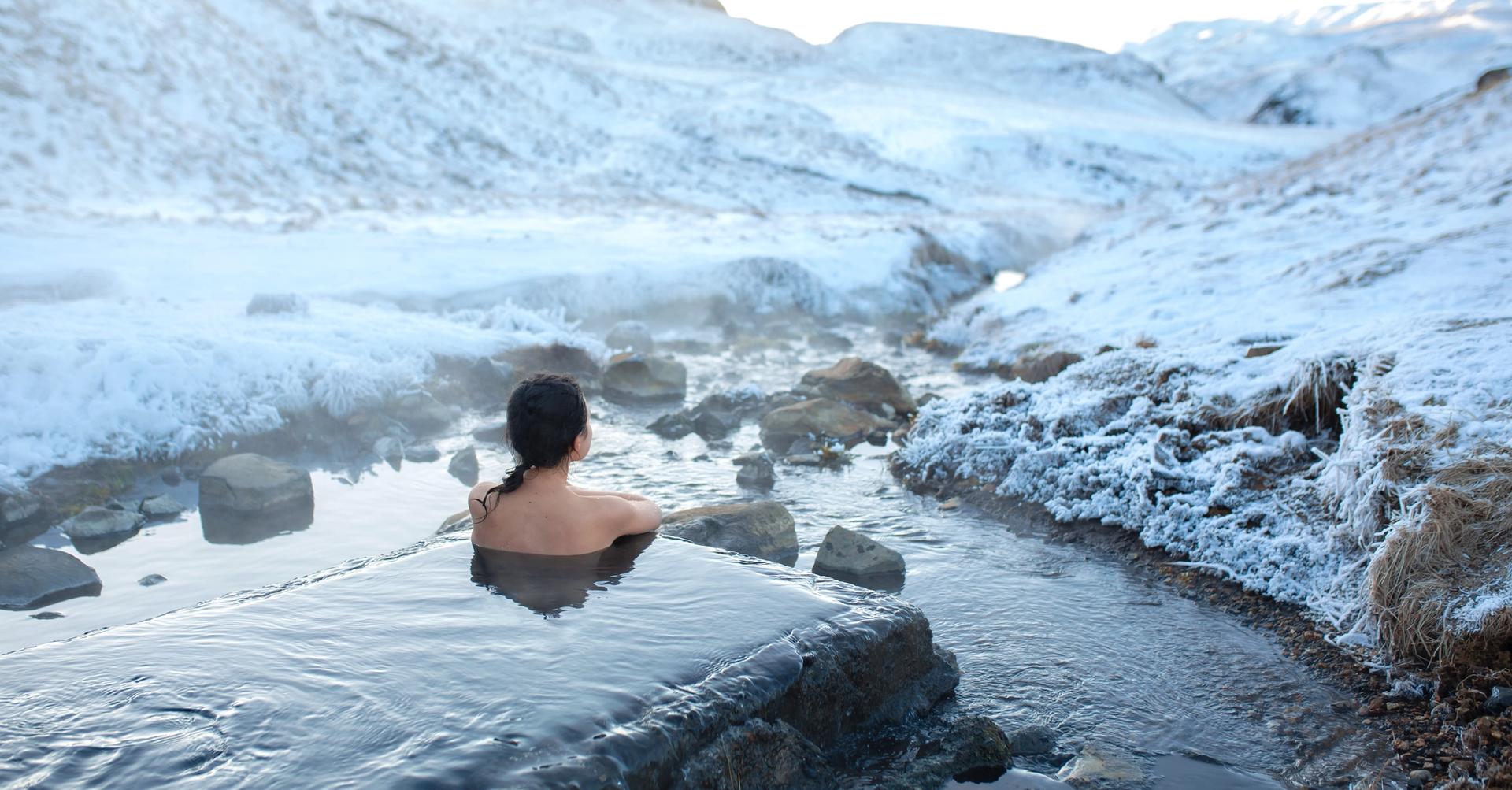A woman relaxing in a hot spring in Iceland