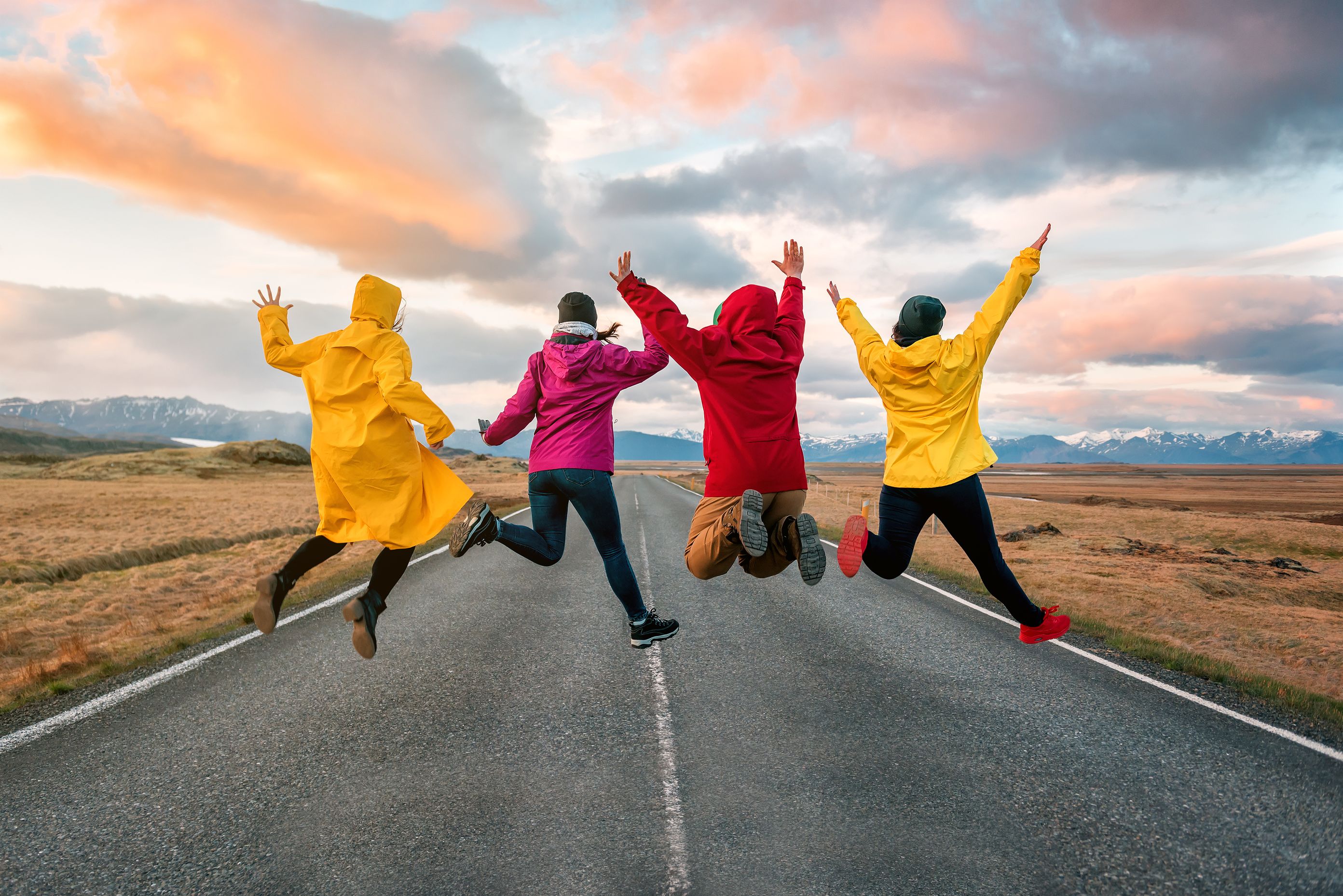 Four friends jumping in Iceland, expressing pure happiness