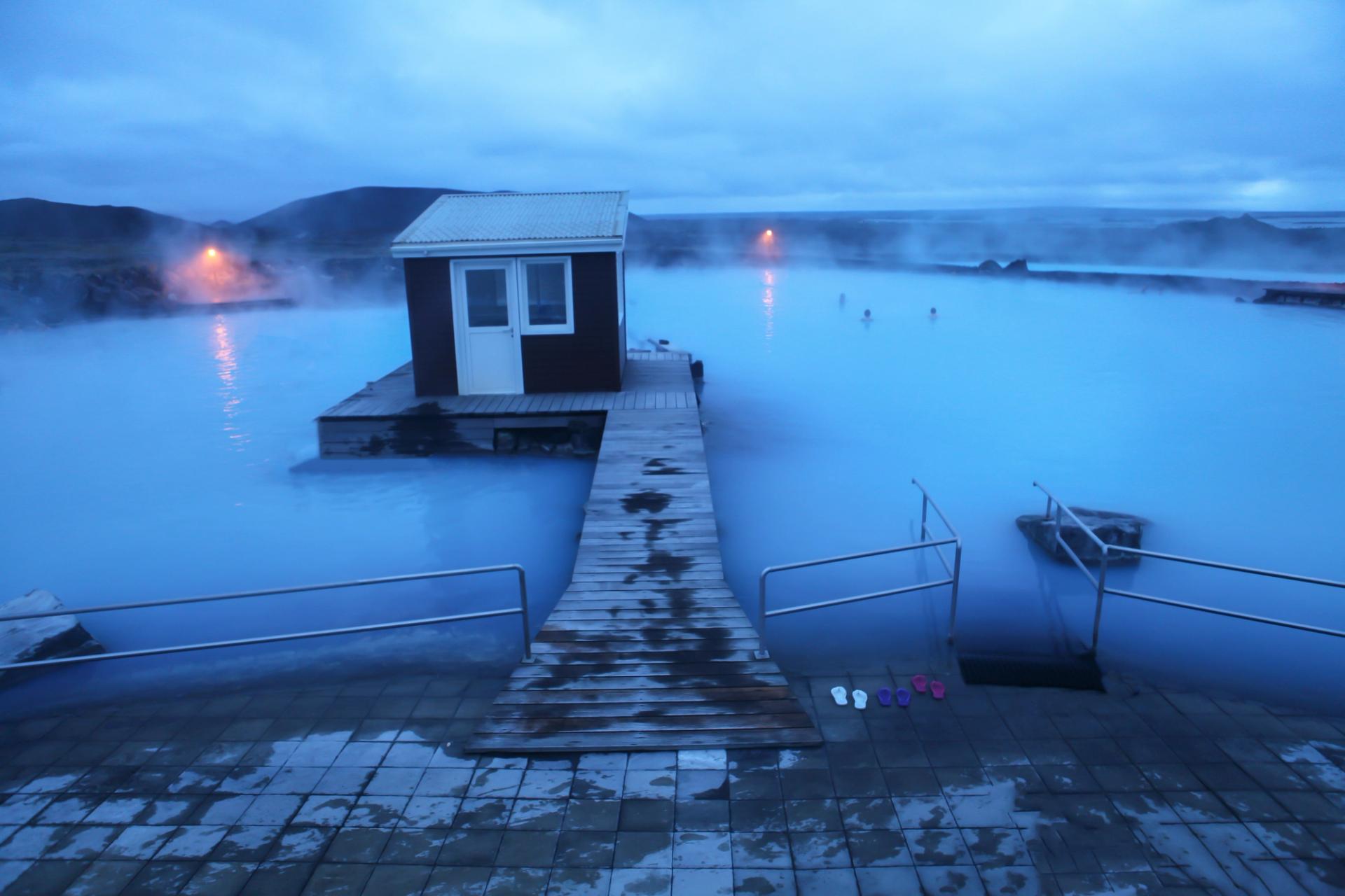 Aerial view of the Mývatn Nature Baths in Iceland with people swimming in the mineral rich waters