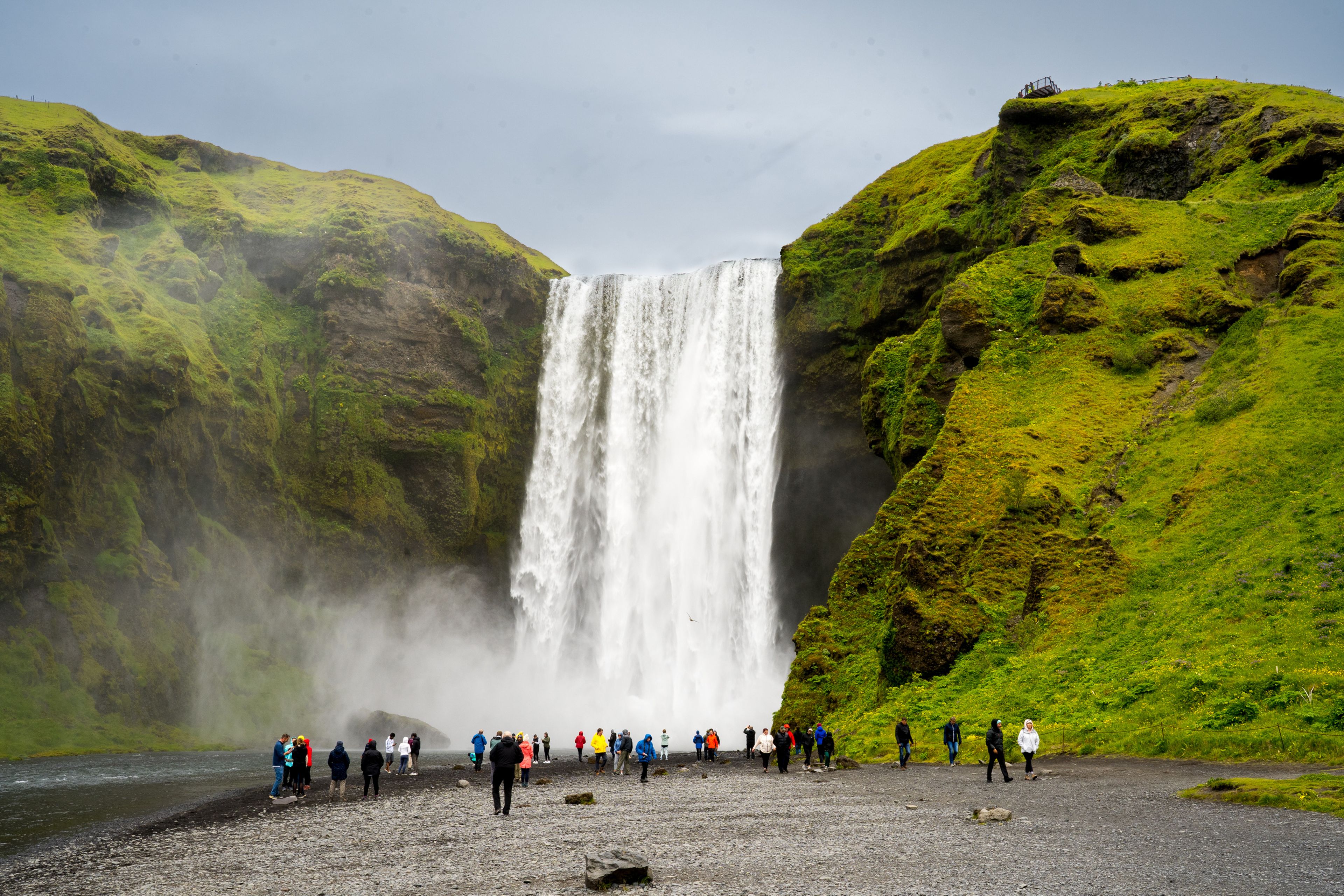 Skógafoss waterfall full of tourists in July