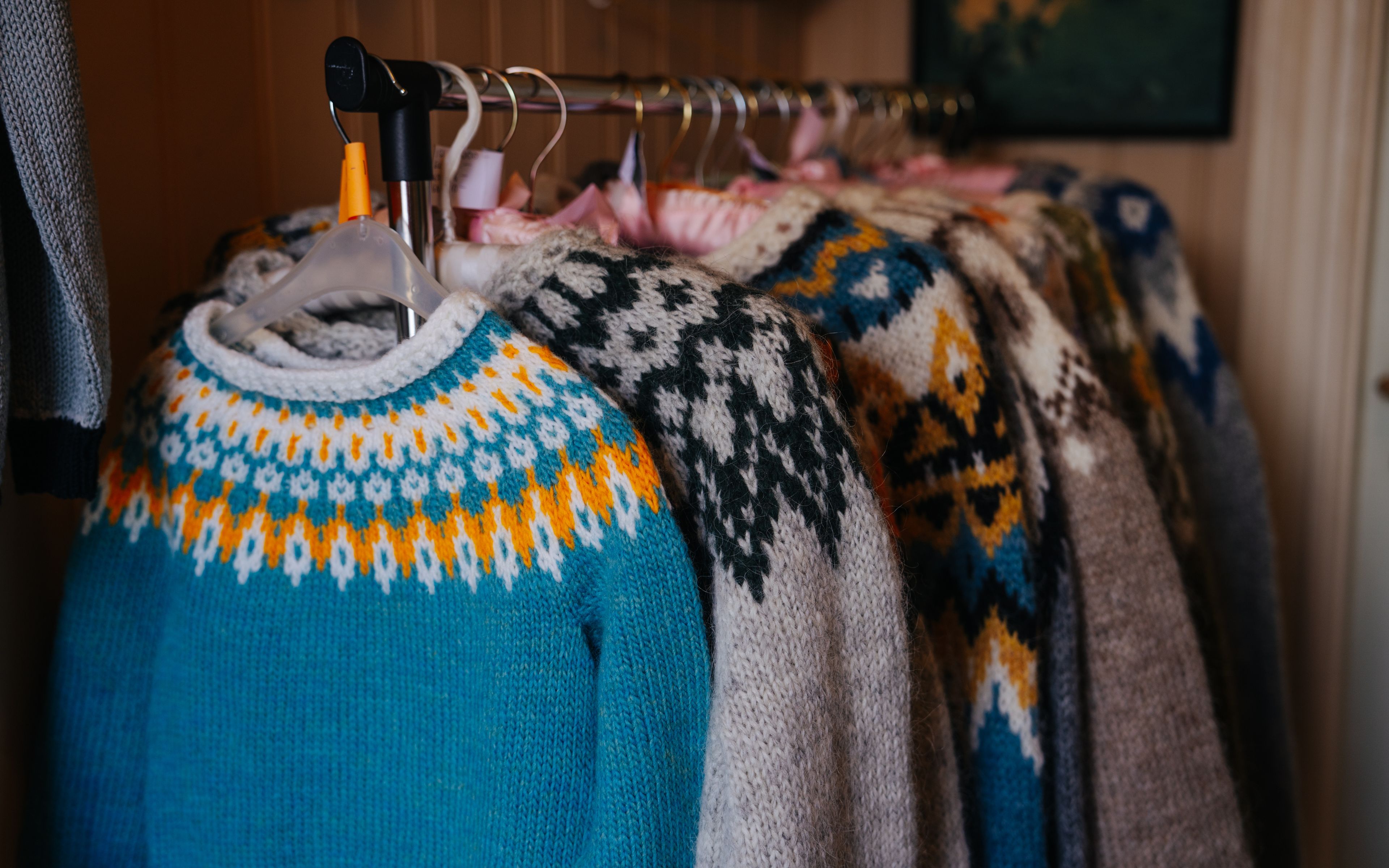 Many lopapeysa sweaters hanging of a rack