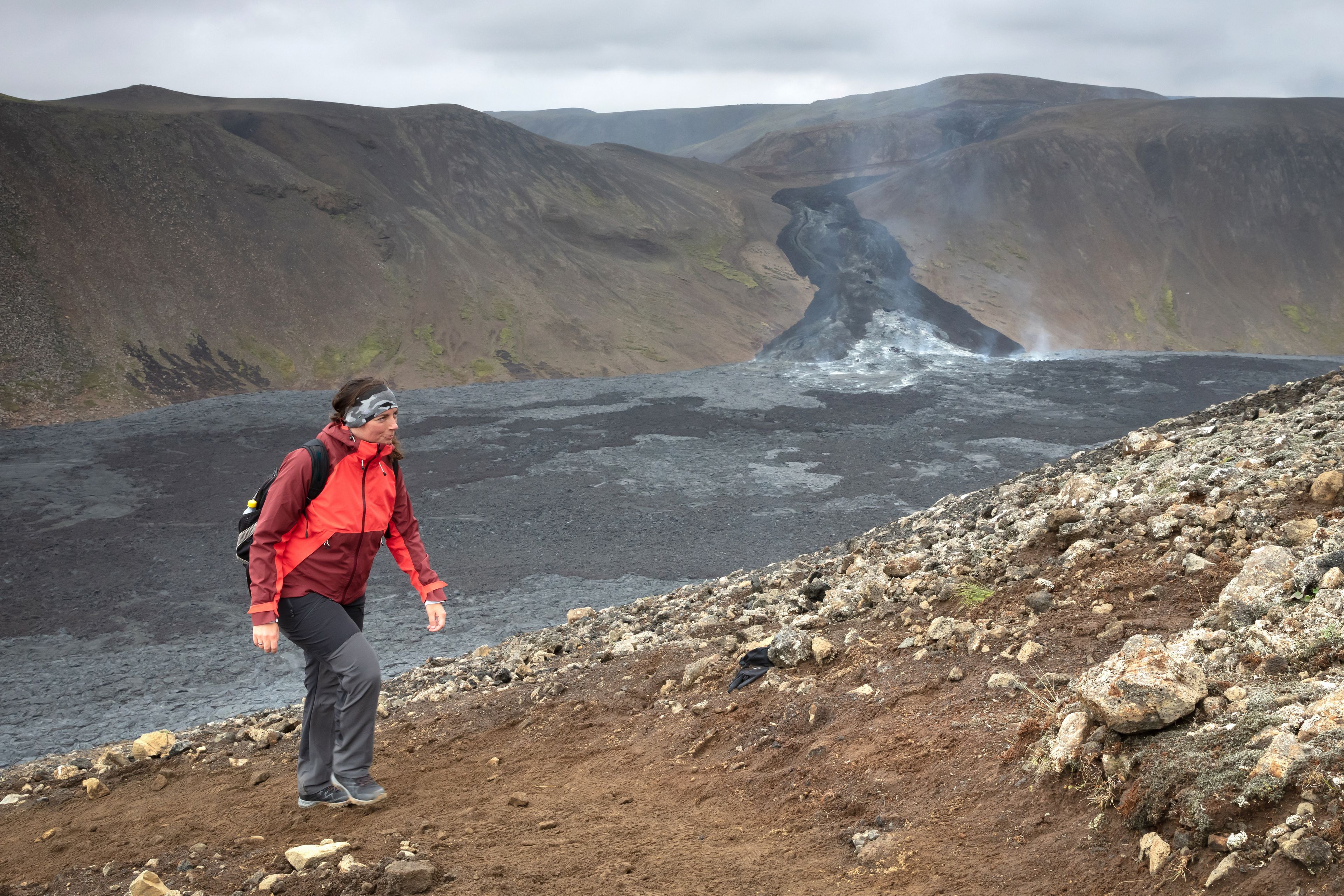 A view of a hiking path in Iceland with volcanic activity in the background