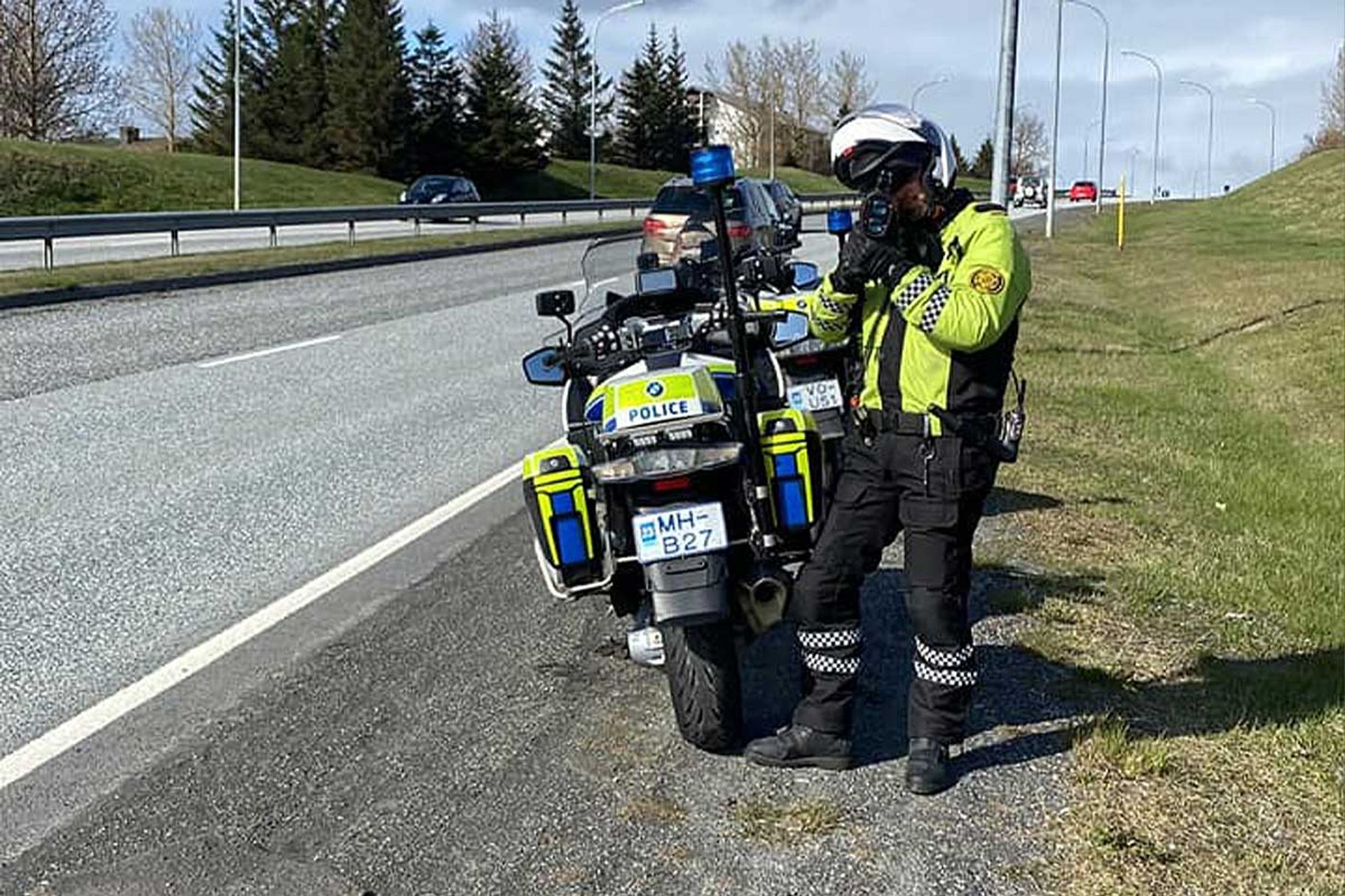 Icelandic police officer operating a speed camera by the roadside