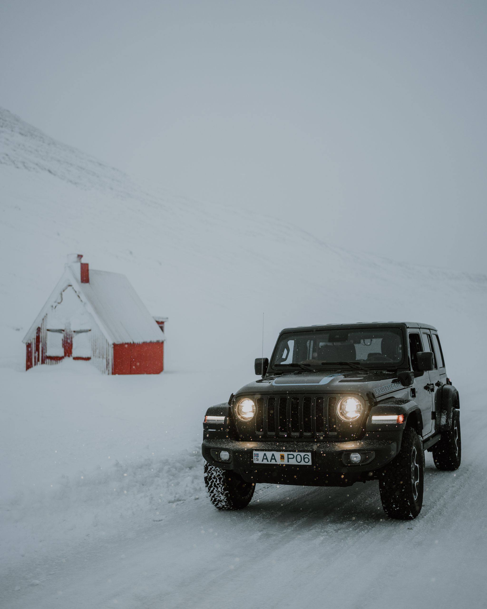 A view of a car driving on a road in Iceland during winter