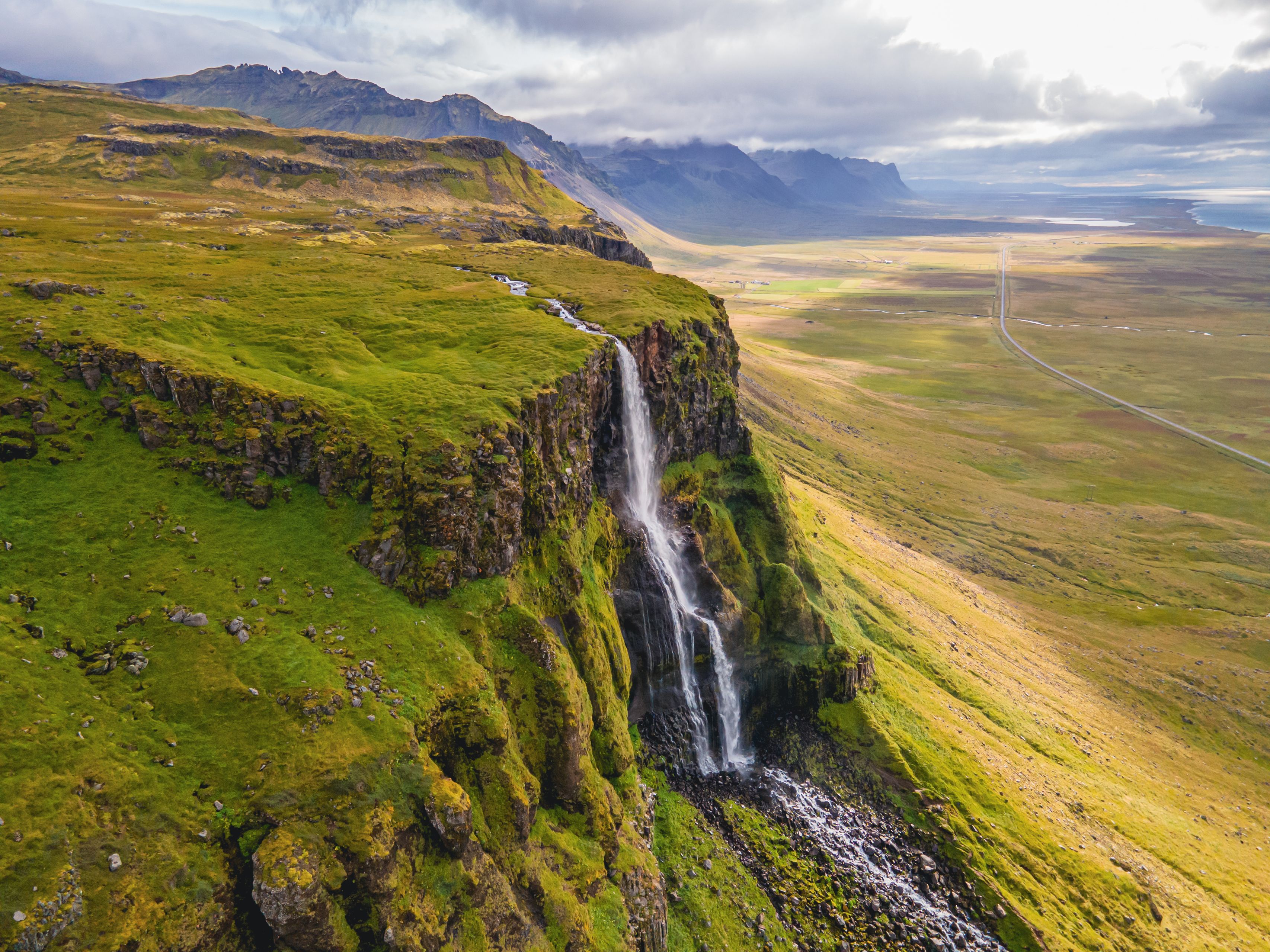 aerial view of a waterfall falling from a big cliff 