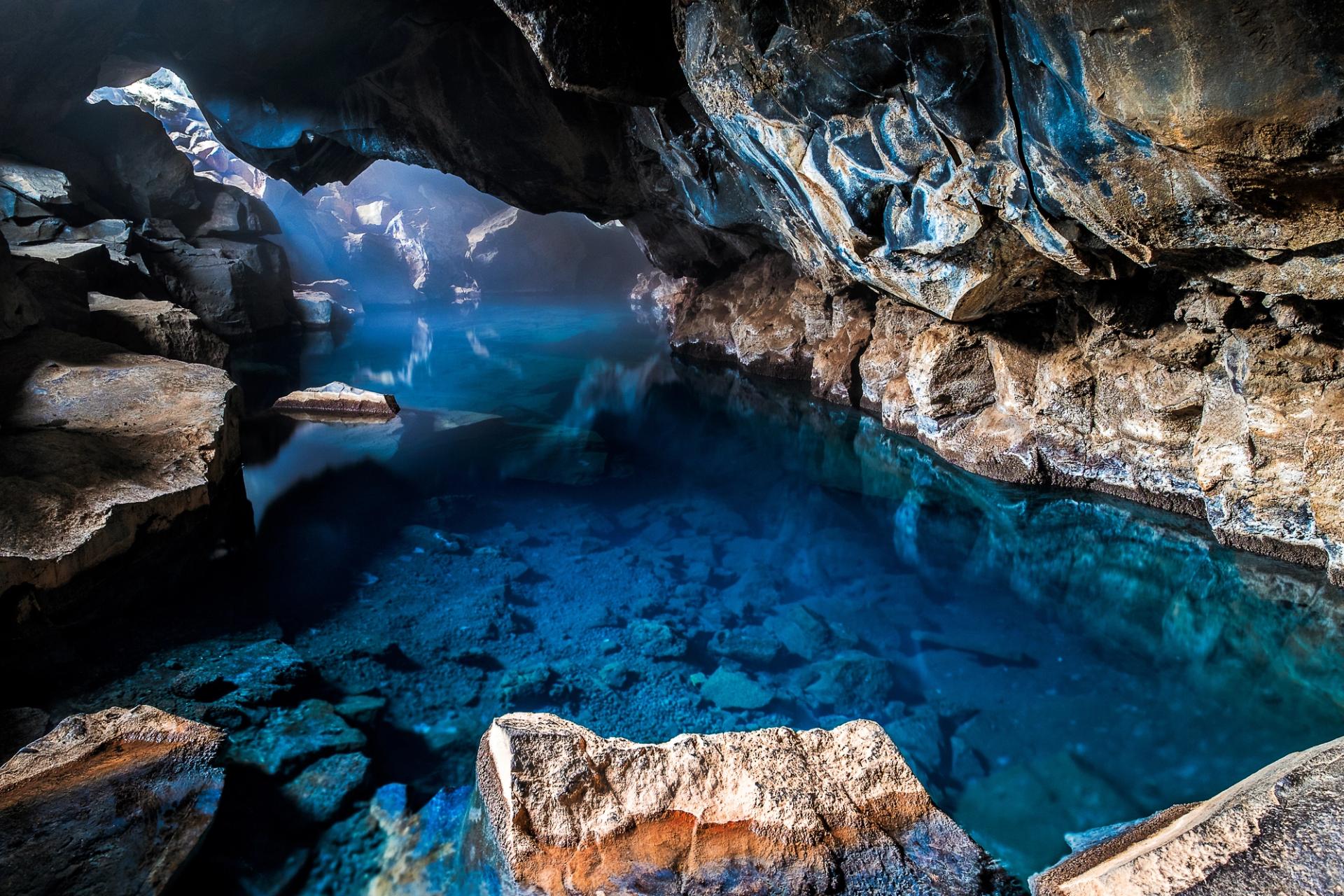 Picture of the Grjotagja volcanic Cave, with hot blue thermal water