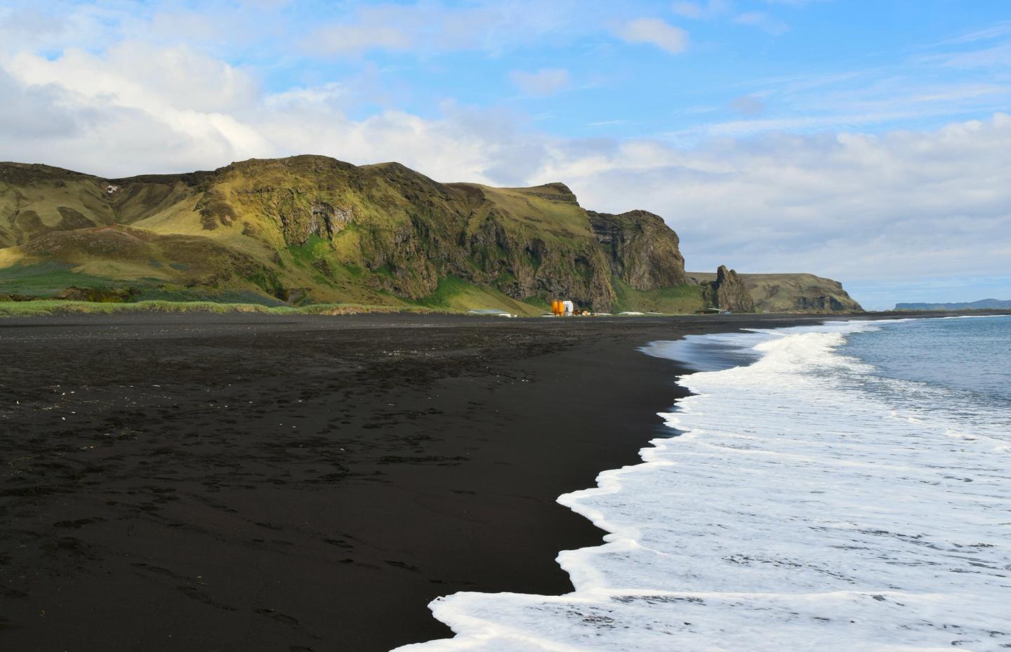 a large Black sand beach in Iceland near a small town called vik