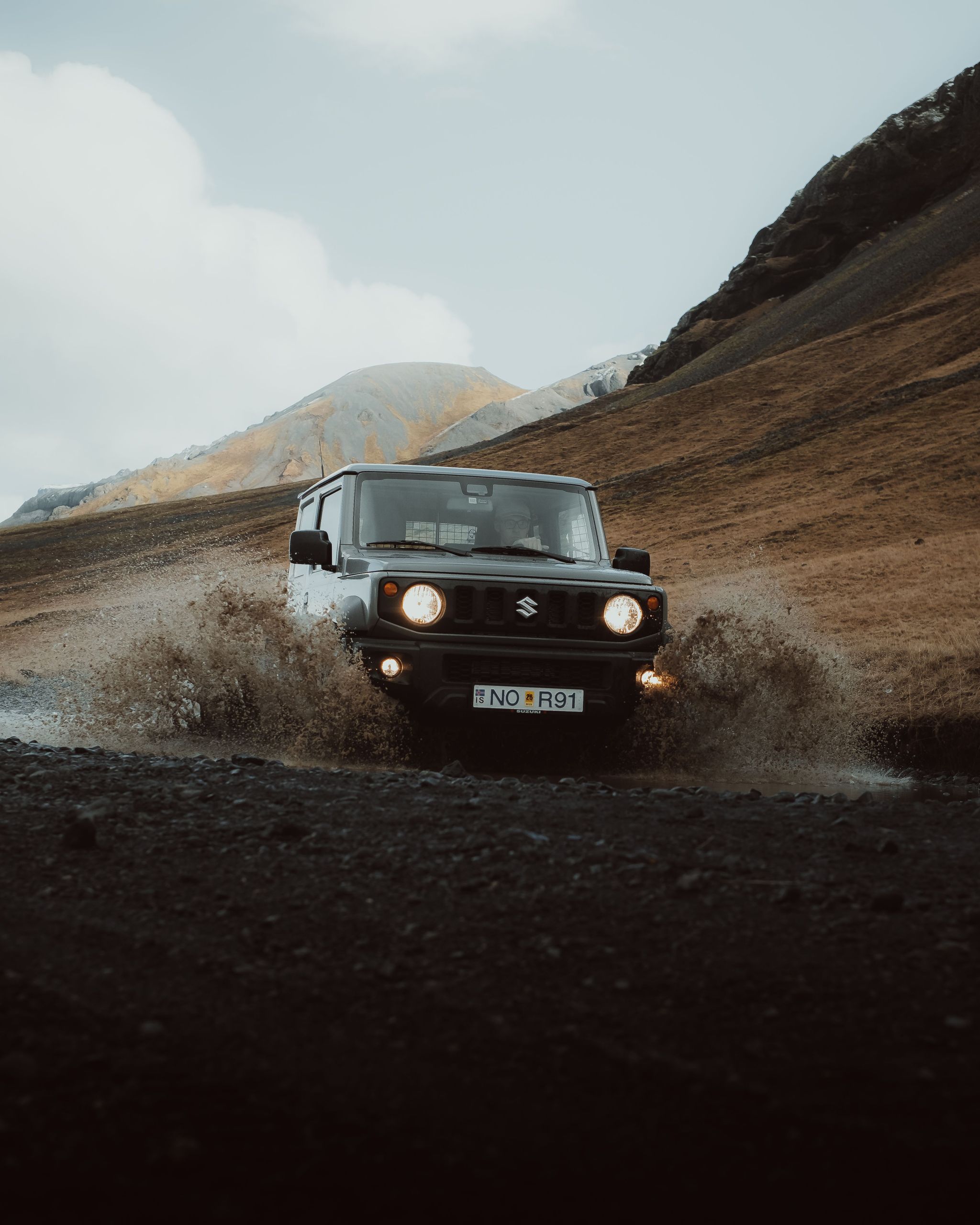 Suzuki Jimny crossing a small pond