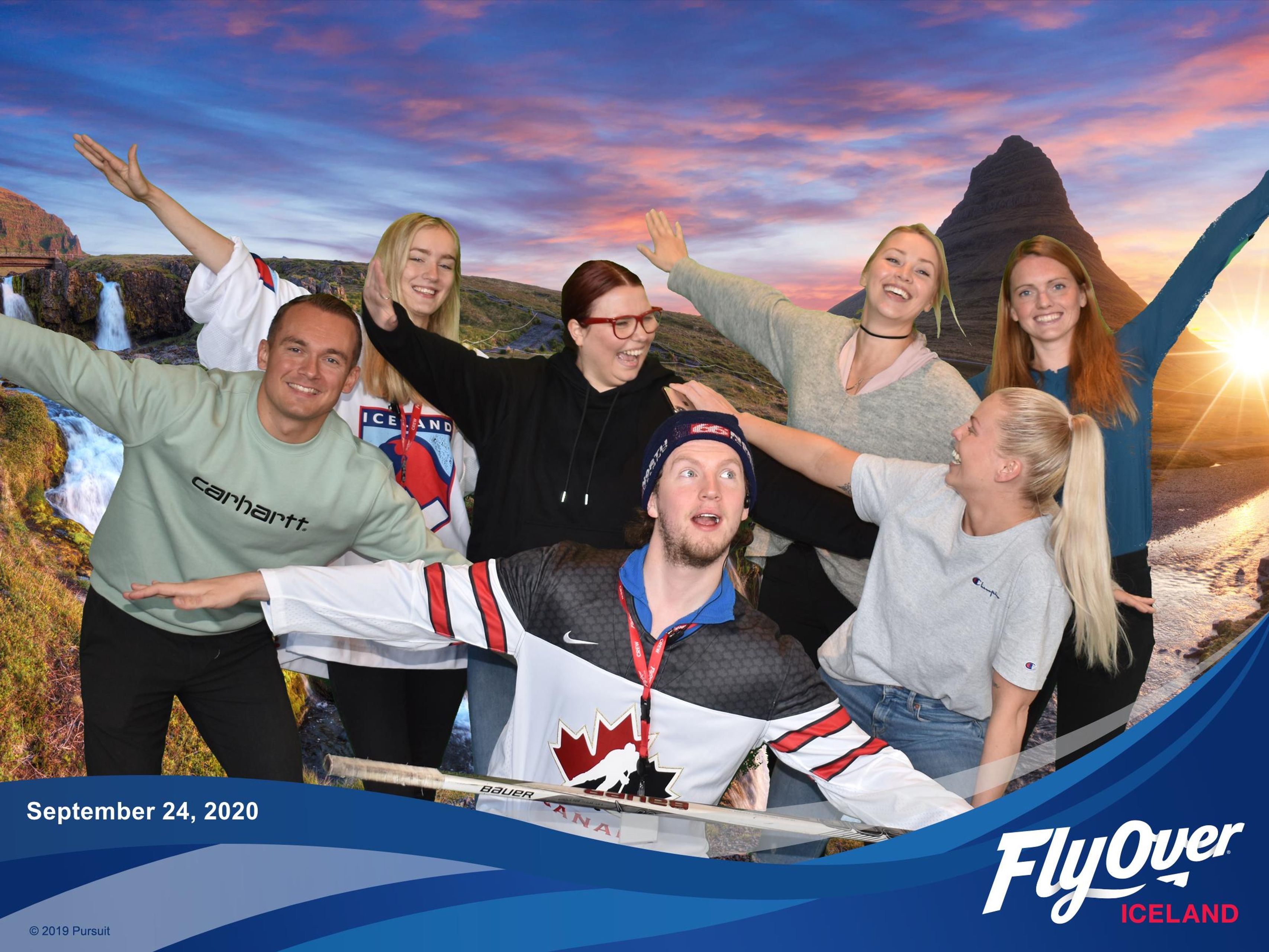 Staff at flyover iceland taking a photo of them flying