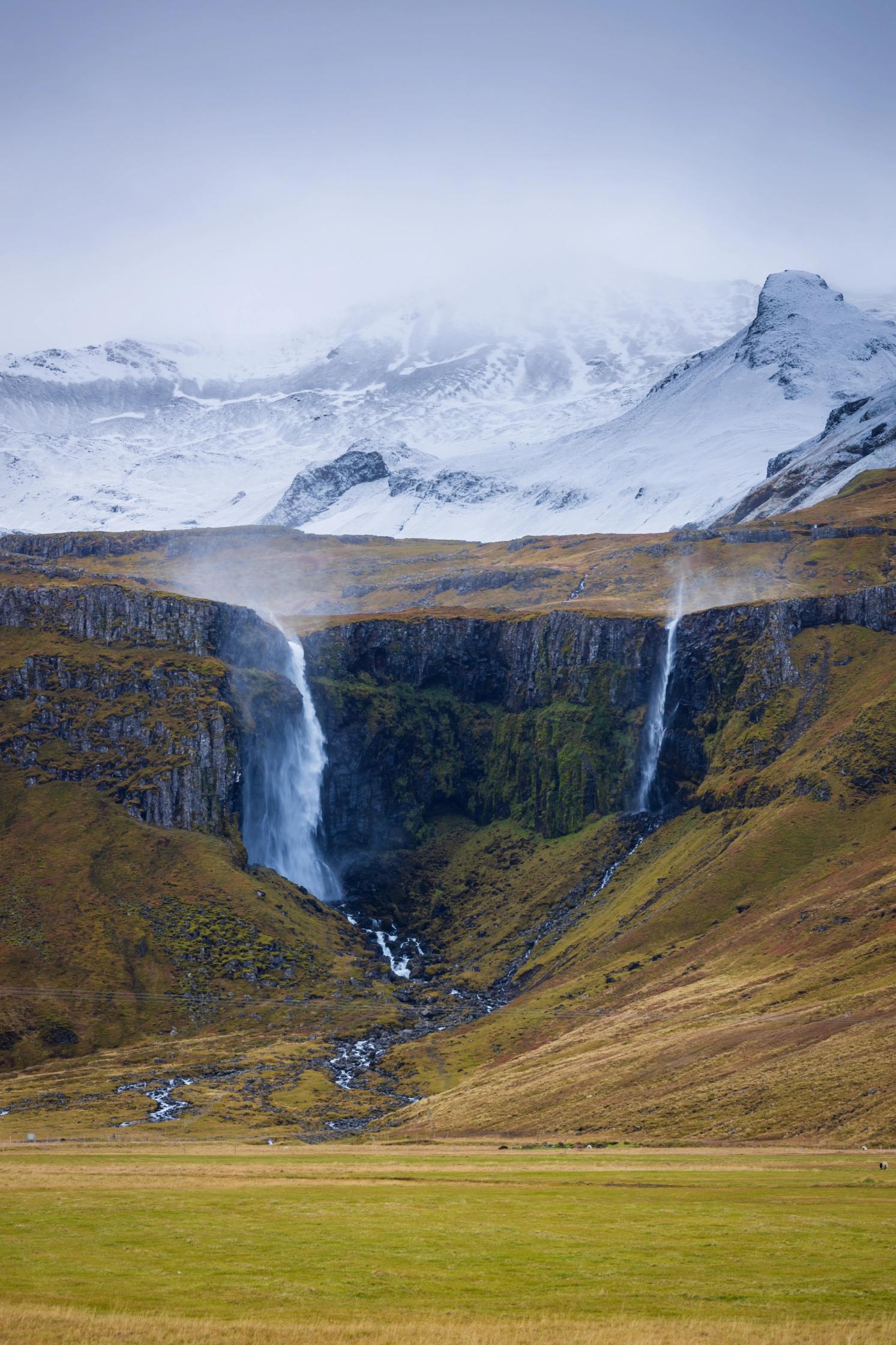 Panoramic view of Grundarfoss with snowed mountains in the background