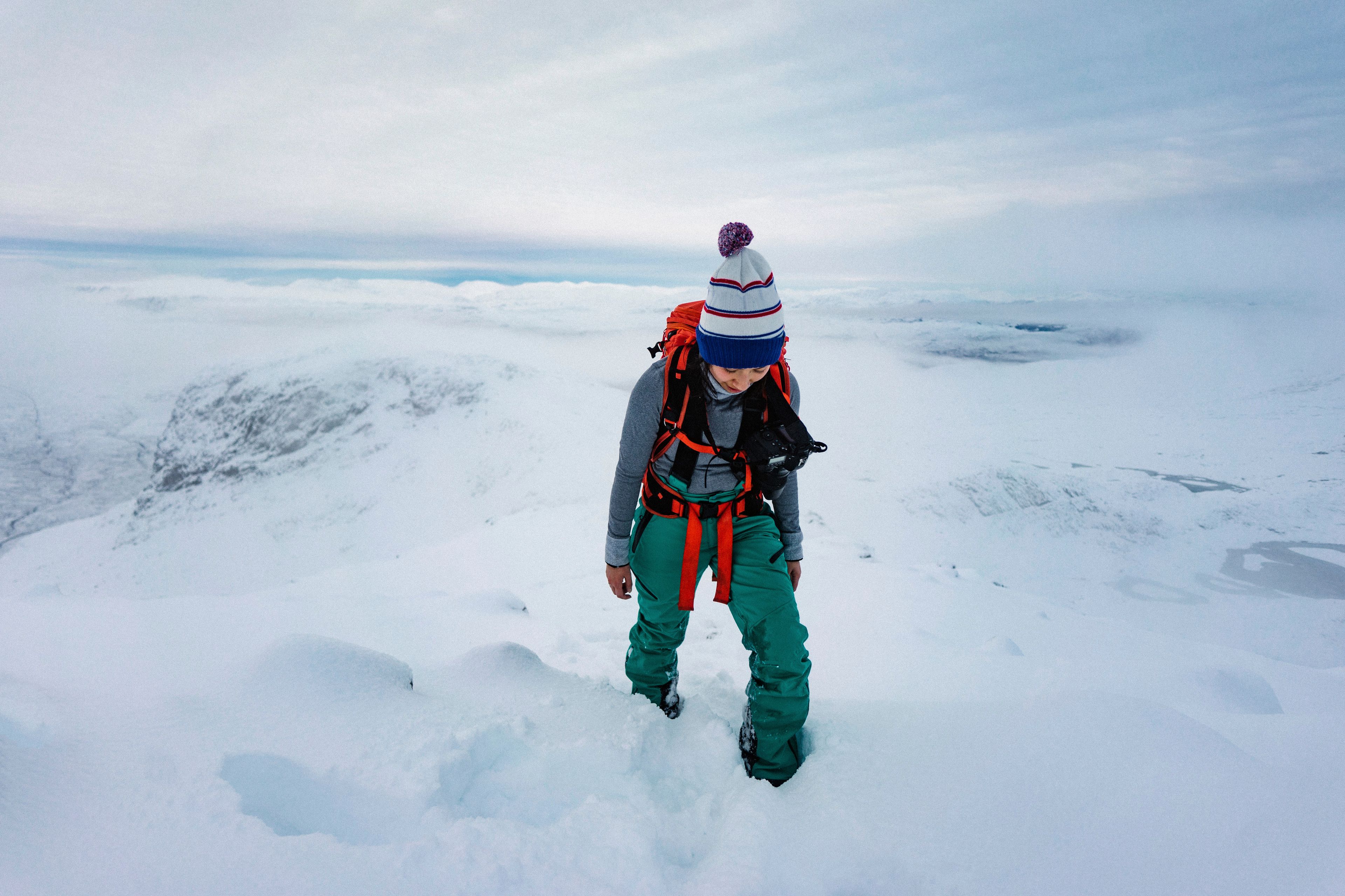 Girl trekking a snowed mountain