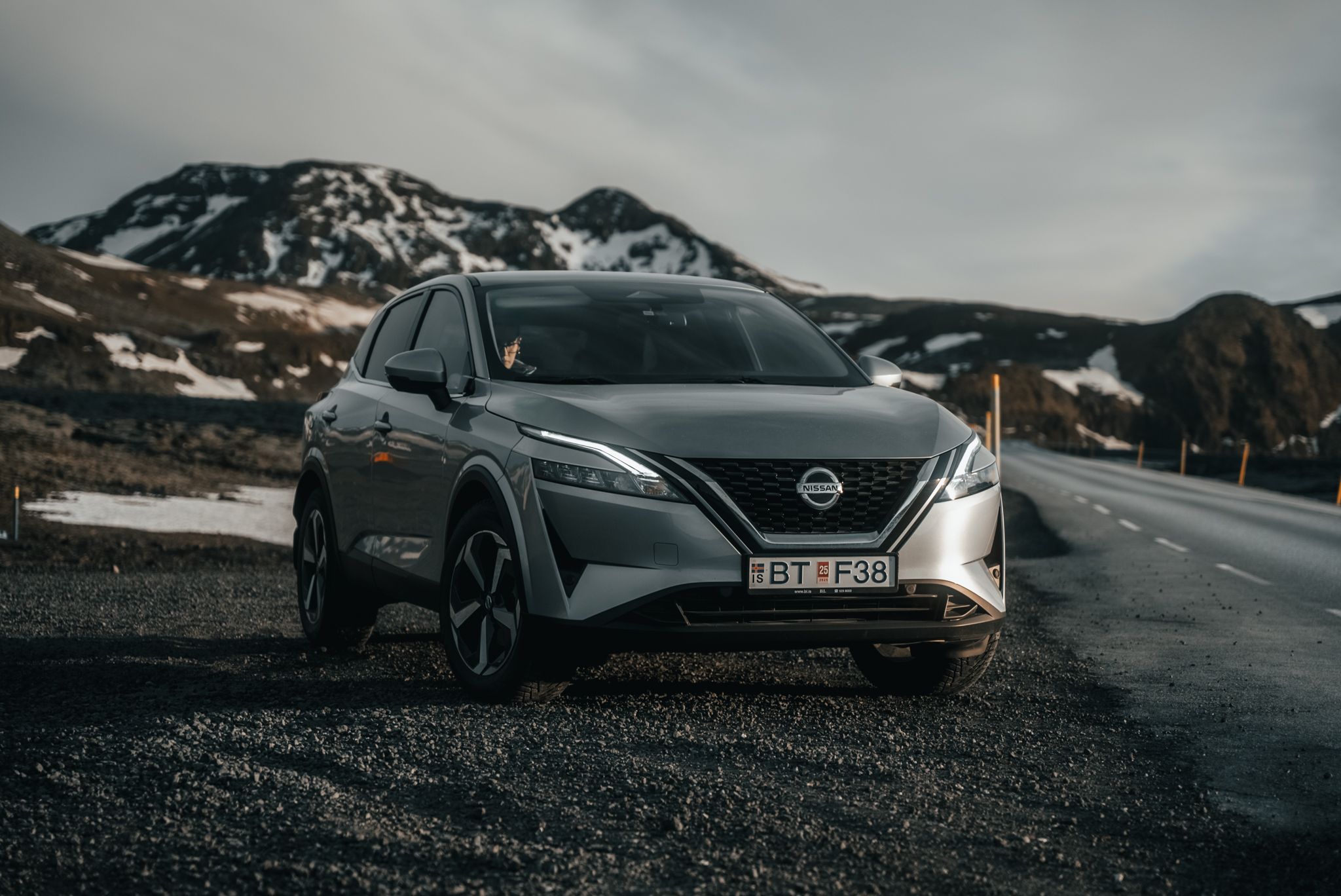 Nissan Qashqai vehicle parked on an open road in the beautiful landscapes of Iceland.