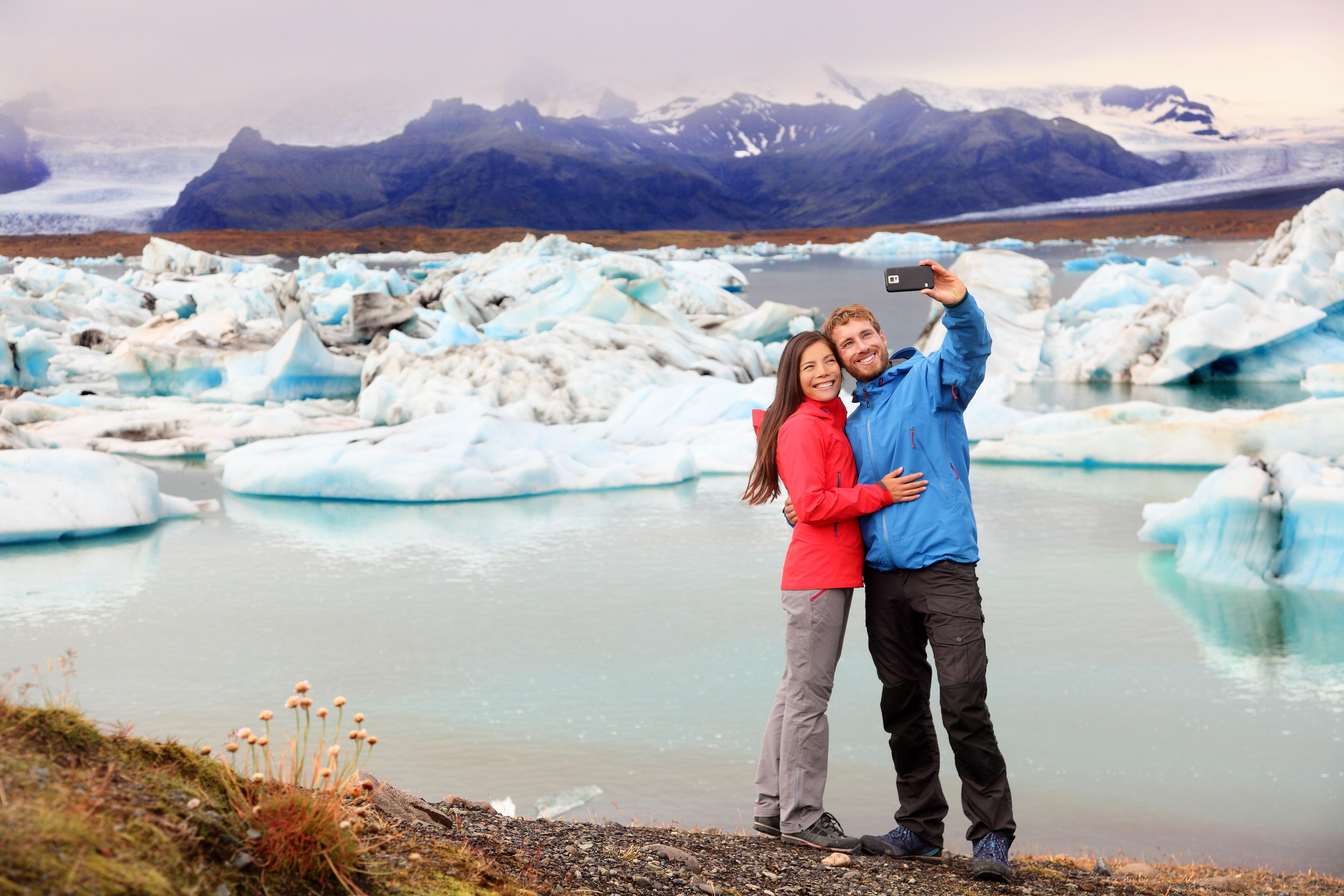 Couple taking selfie by Jokulsarlon in Iceland in April