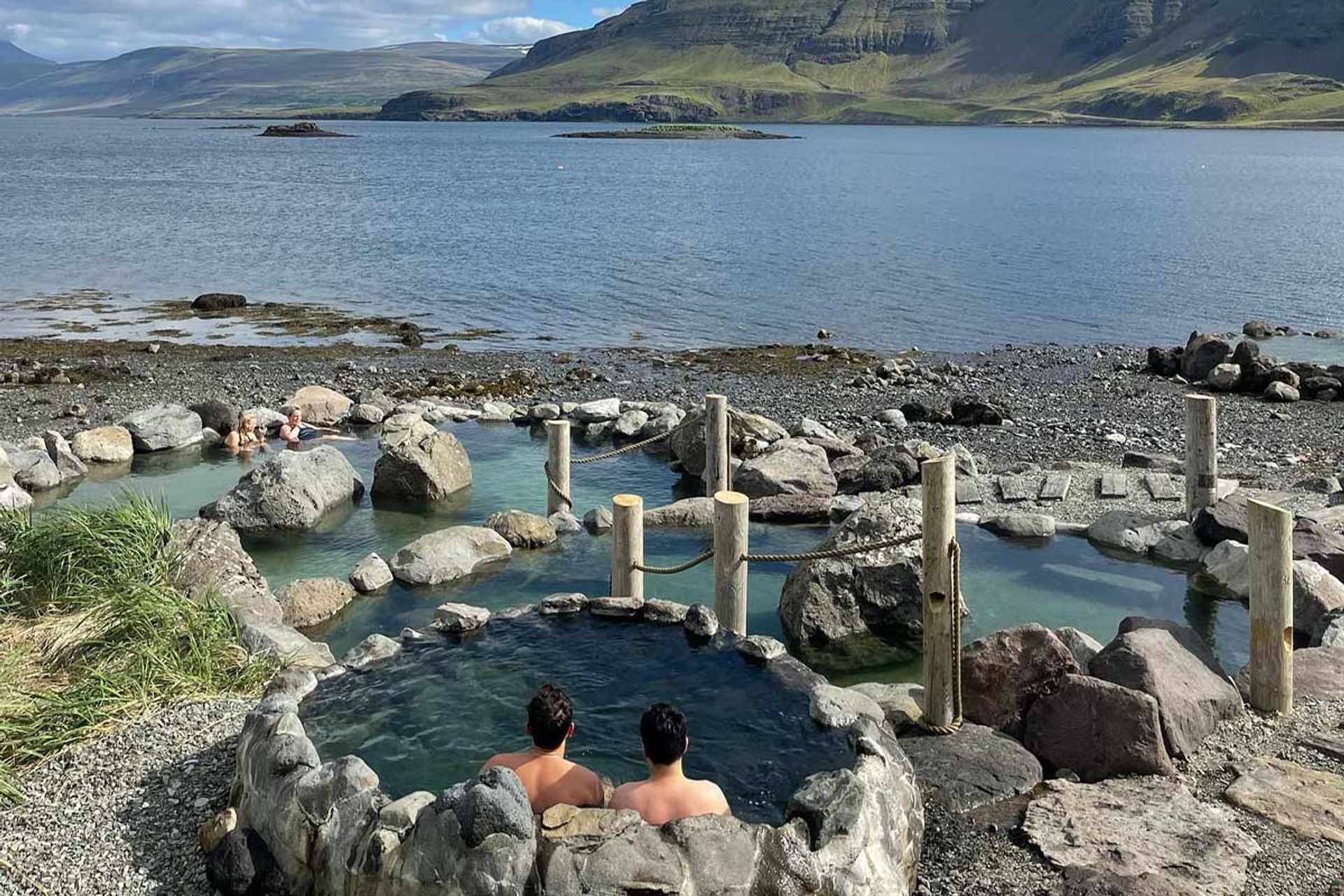 Friends relaxing in Hvammsvik Hot Spring in Iceland near Reykjavik