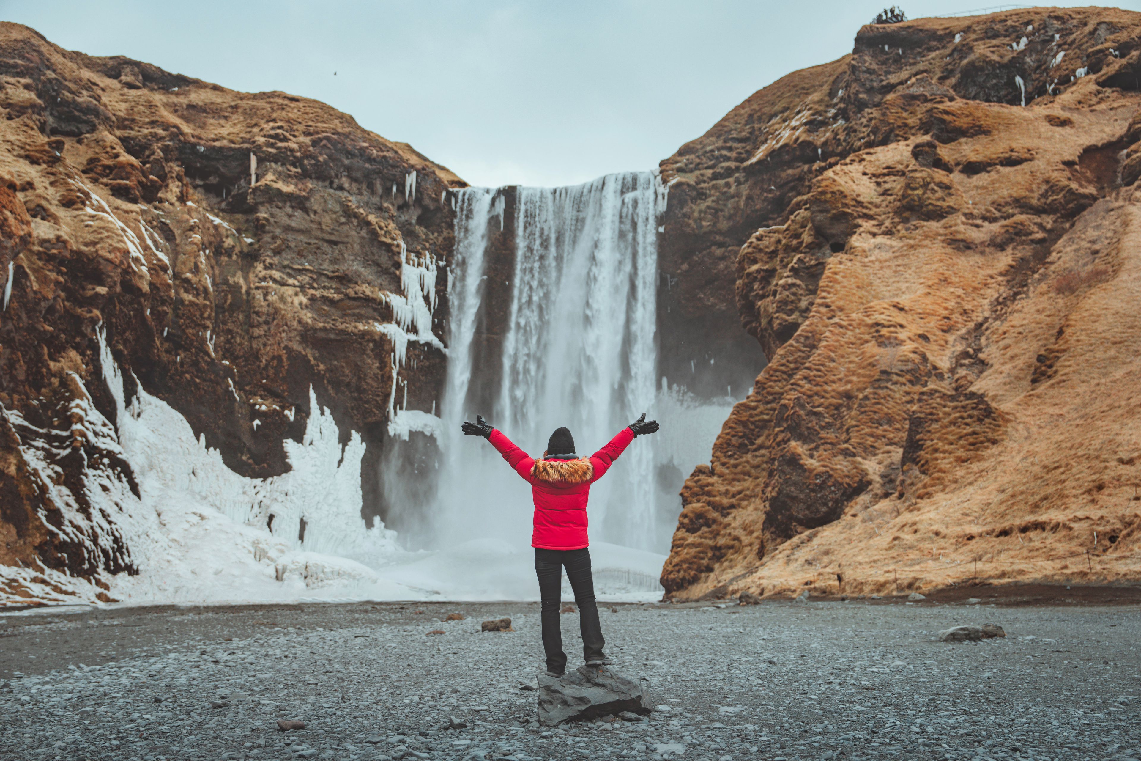 Girl in front of Skógafoss waterfall