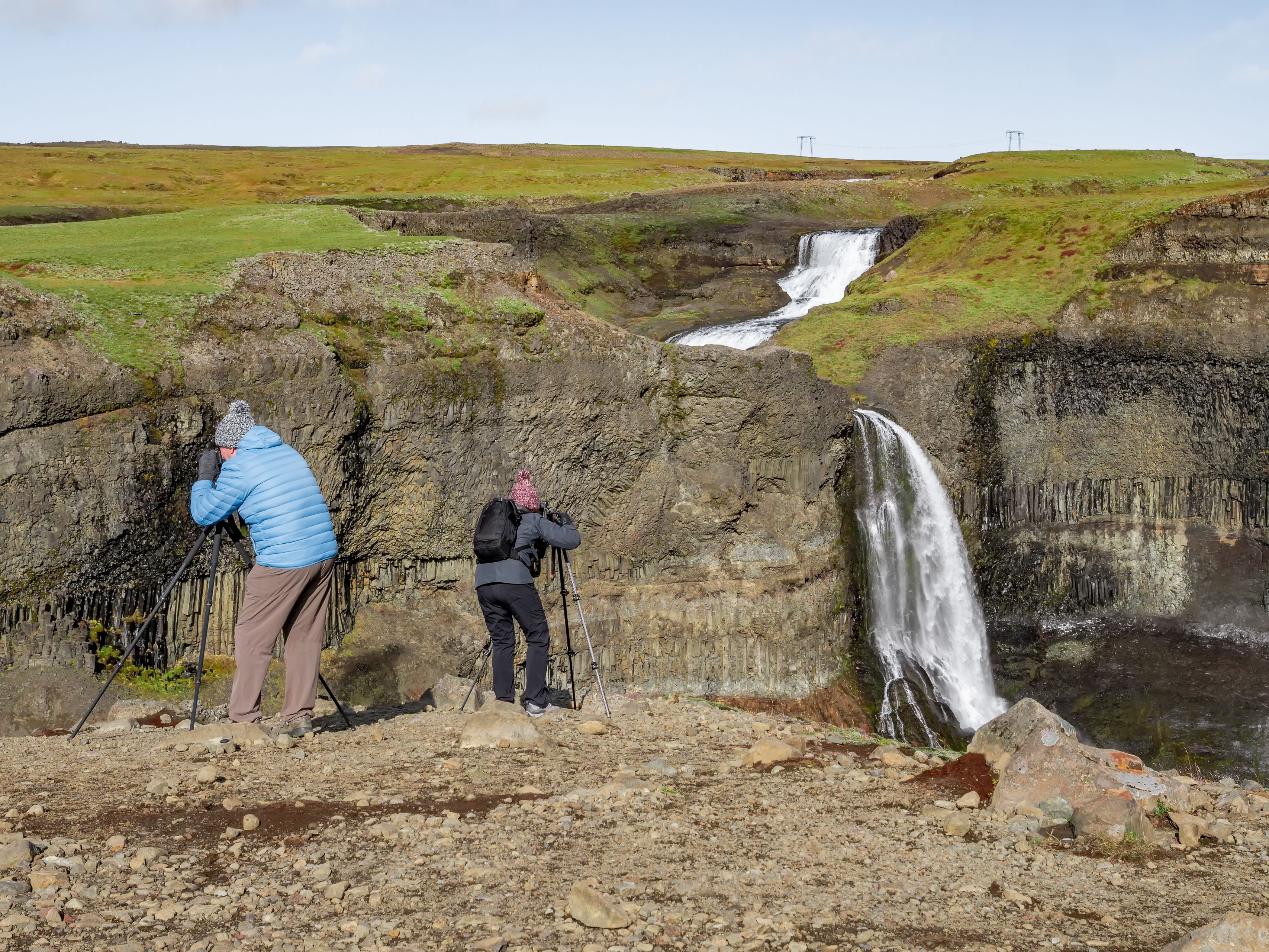 Two men taking pictures of Haifoss waterfall in Iceland