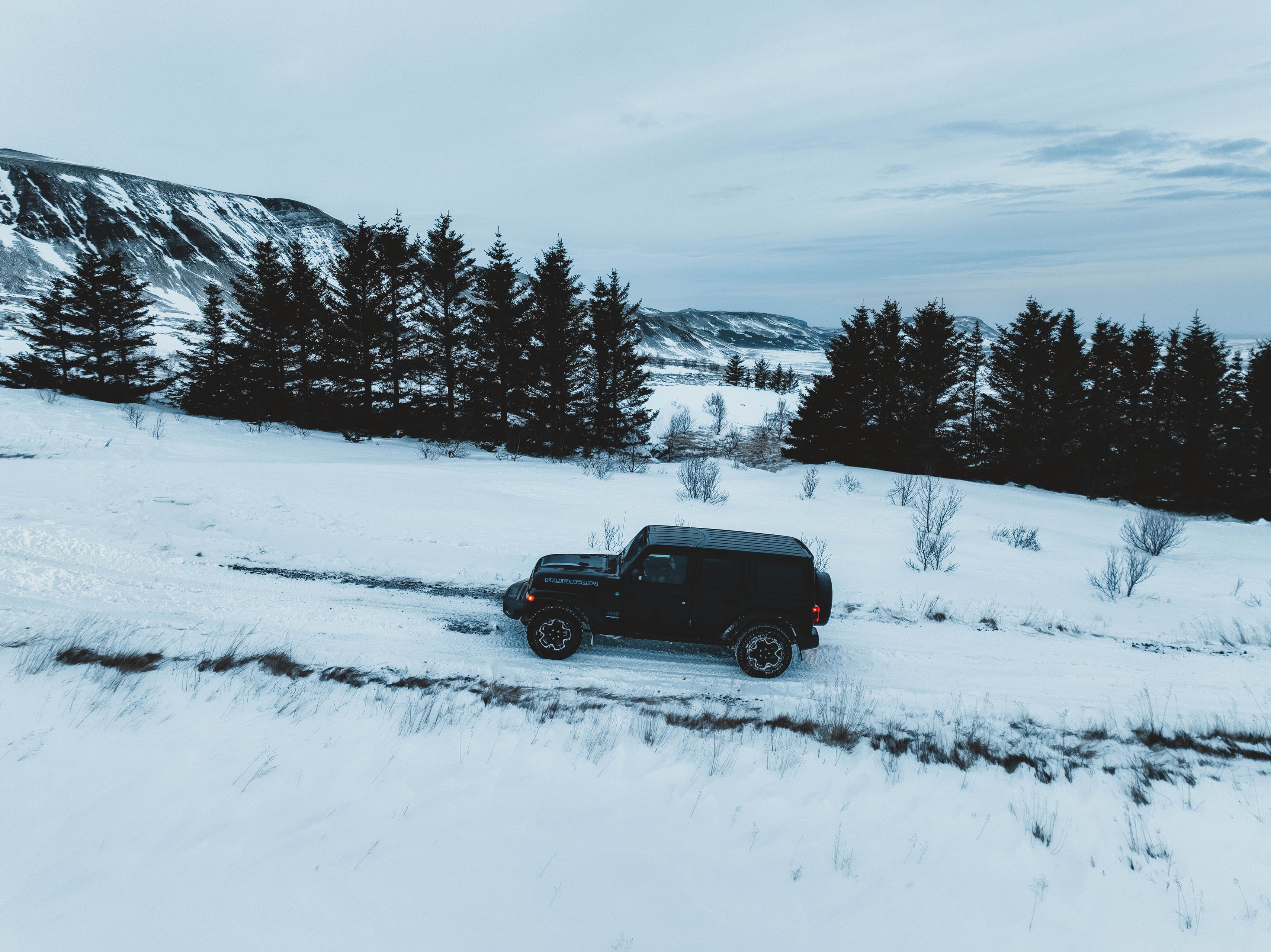 Black 4x4 in the cold landscapes of Iceland where the snow is predominant