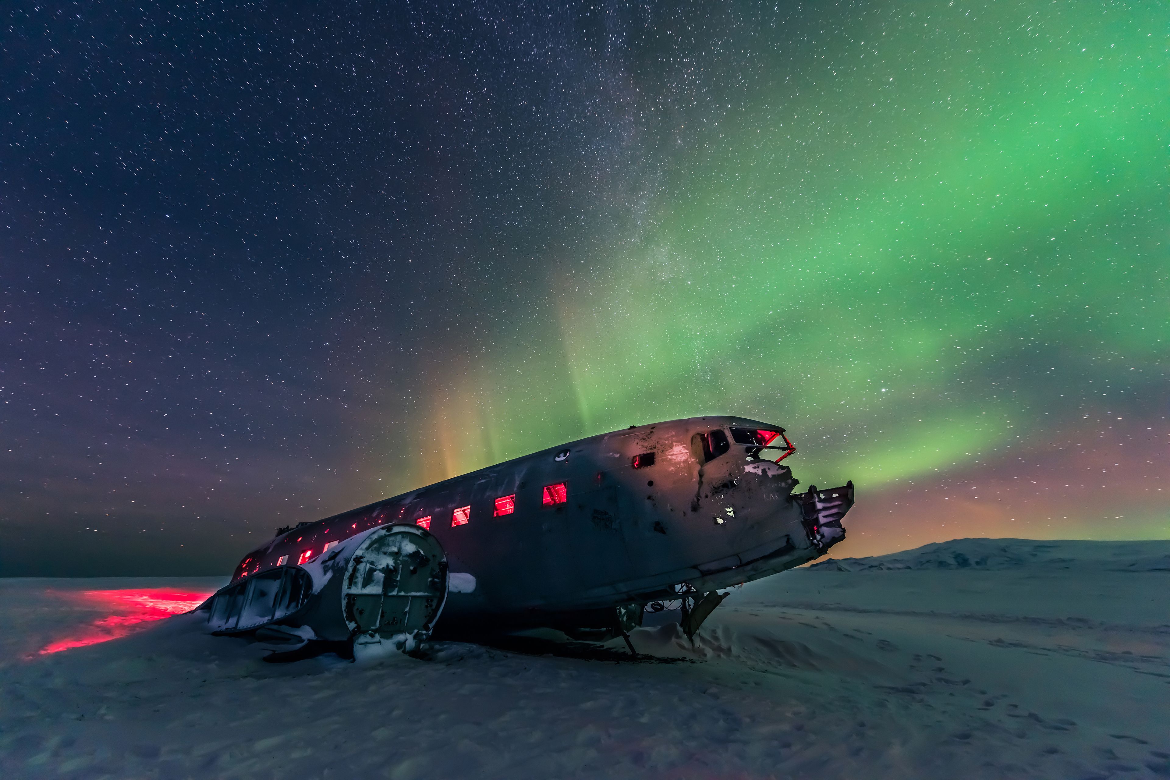 Northern lights over Abandoned DC Plane on Sólheimasandur Iceland