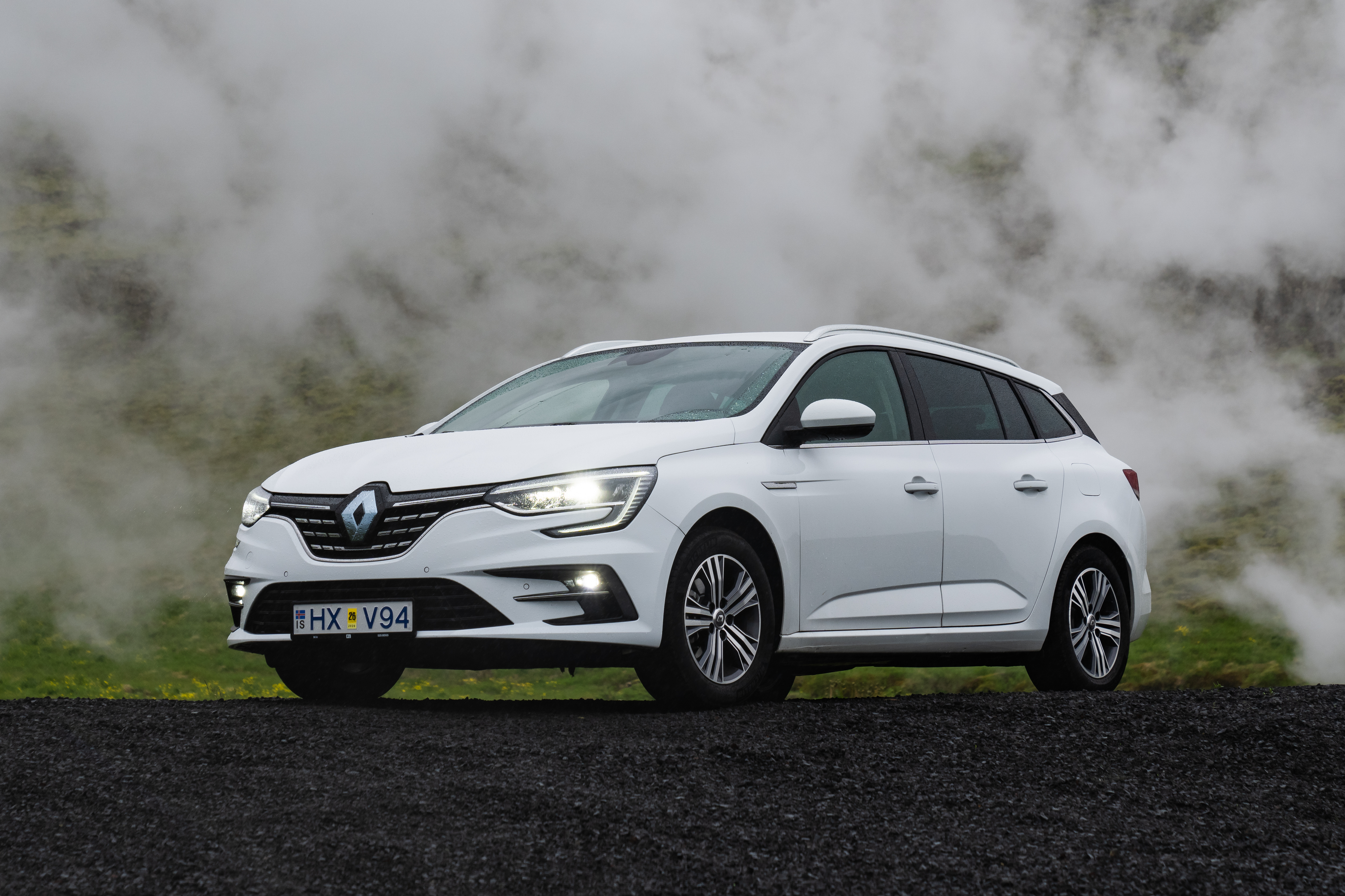 A white Renault Megane rental car from Go Car Rental, parked outside.