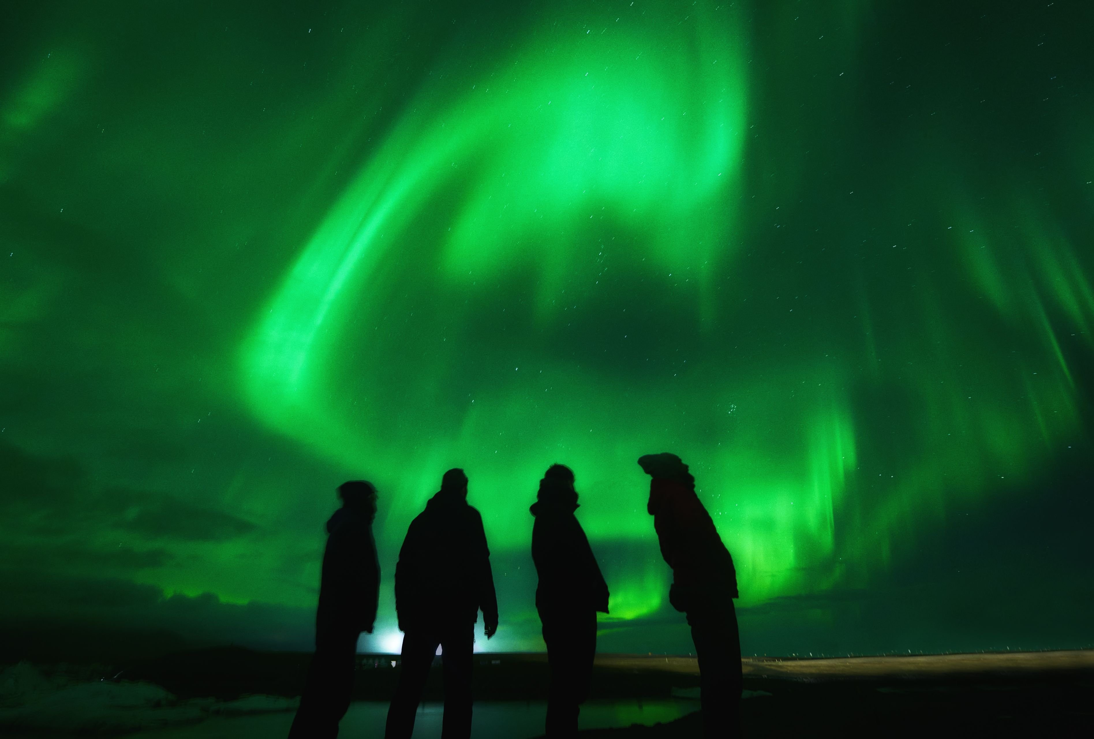 Group of friends under northern lights