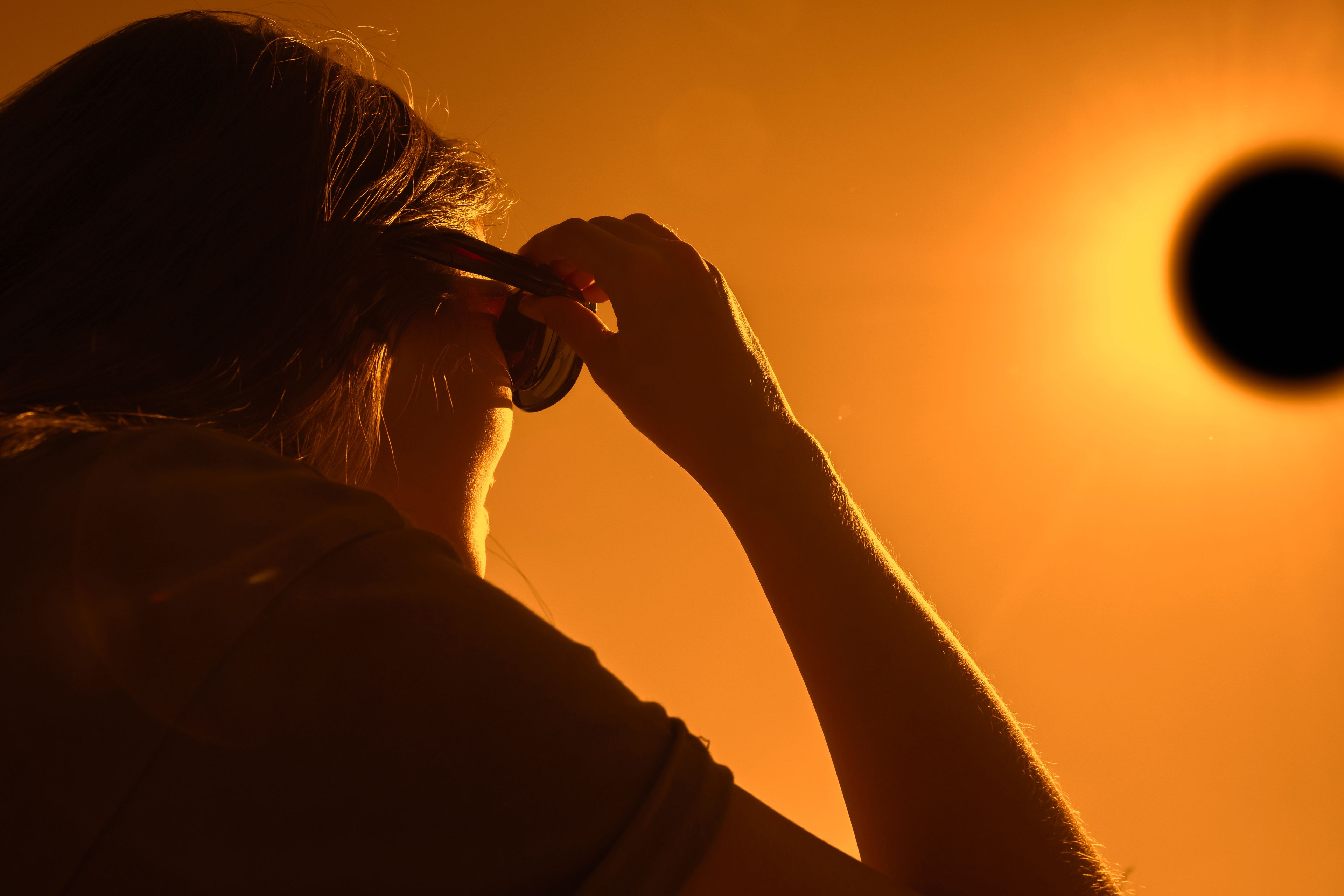 Girl watching an eclipse with her glasses on